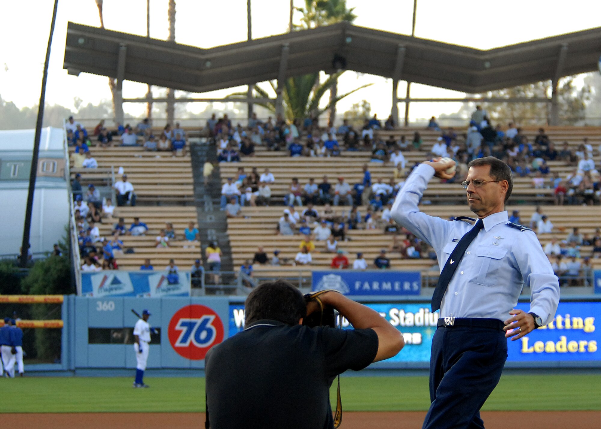 Lt. Gen. Tom Scheriden, Space and Missile Systems Center commander, throws the ceremonial first pitch at the Dodger Game celebrating the El Segundo community as a local photographer takes his photo, July 26. (Photo by Stephen Schester)