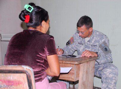 SANTA BARBARA, Honduras - Army Col. Otto Boneta, Joint Task Force-Bravo Medical Element commander, examines a patient during a medical readiness training exercise here July 25. More than 740 people attended the MEDRETE for access to free medical care and preventative health measures. (U.S. Air Force photo by Staff Sgt. Joel Mease)