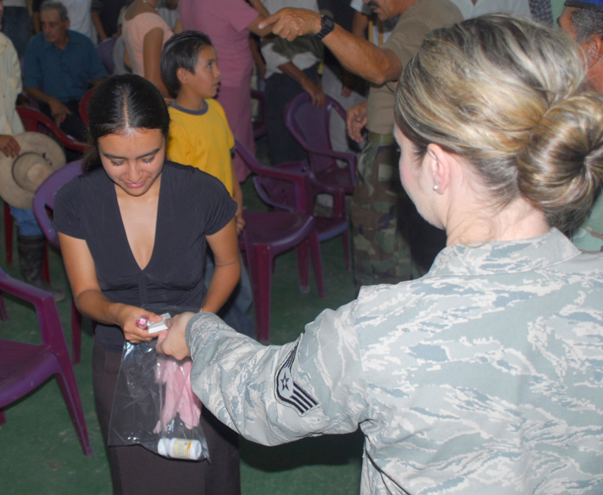 SANTA BARBARA, Honduras - Air force Staff Sgt. Jennifer Kiemel, Joint Task Force-Bravo Medical Element, hands out soap to people who attended a medical readiness training exercise in San Antonio De Canada, Honduras, July 25. Among the services provided at the MEDRETE were preventive medicine, health screening, a provider visit and cancer screening. Sergeant Kiemel is deployed from Travis Air Force Base, Calif.