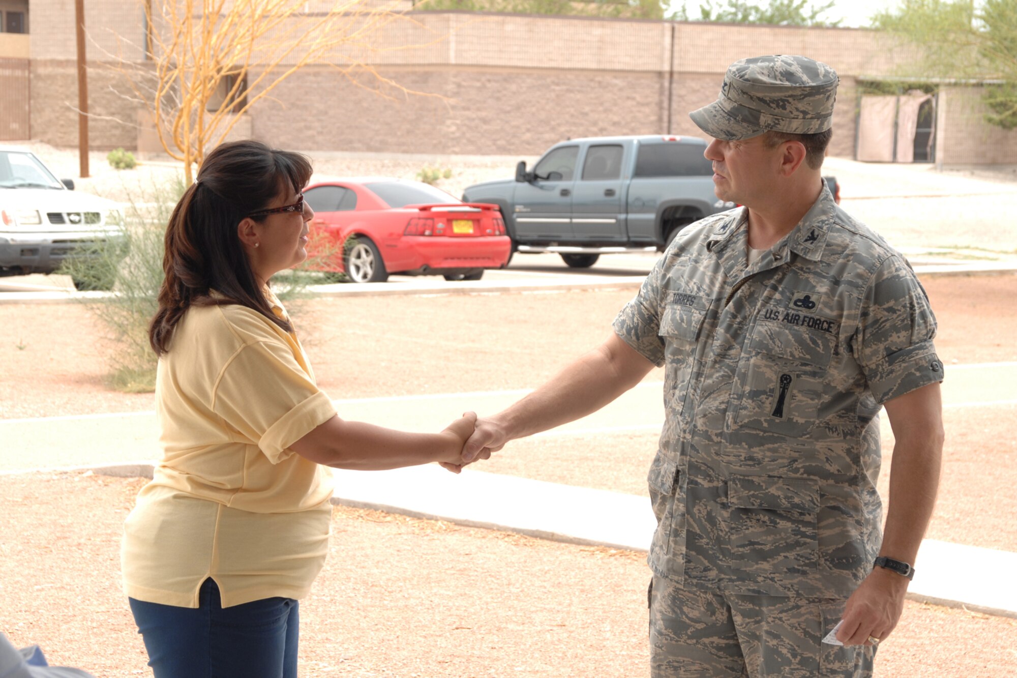 Ms. Cindy Pierpoint, Keep Alamogordo Beautiful director, receives a coin from Col. GeorgeTorres, 49th Maintenance Group commander, during the Keep America Beautiful wrap up June 27 at Holloman Air Force Base, N.M. (U.S. Air Force photo/Airman 1st Class Jamal D. Sutter)