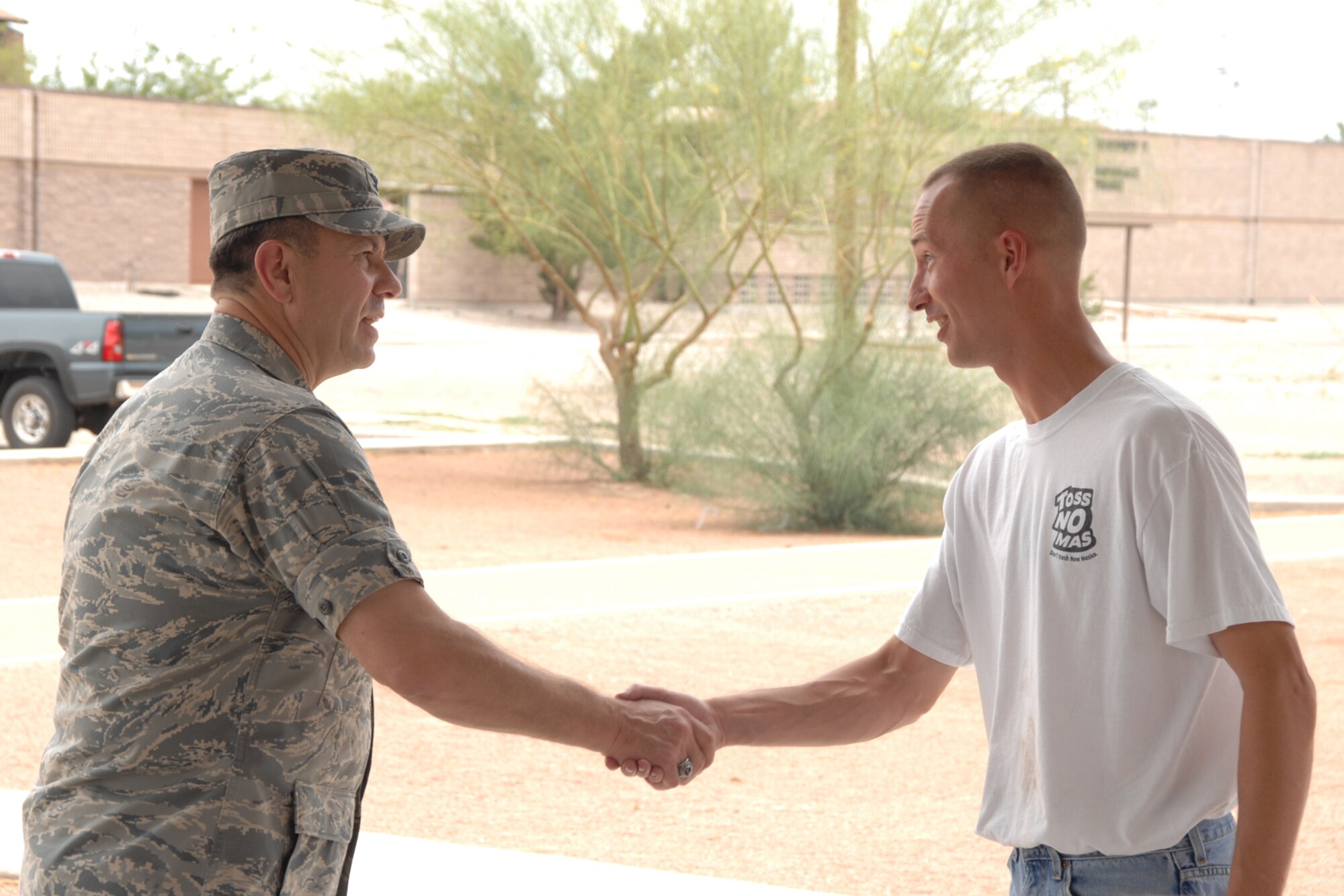 Tech. Sgt. Robin Walker, 49th Maintenance Group, receives a coin from Col. GeorgeTorres, 49 MXG commander, during the Keep America Beautiful wrap up June 27 at Holloman Air Force Base, N.M. (U.S. Air Force photo/Airman 1st Class Jamal D. Sutter)