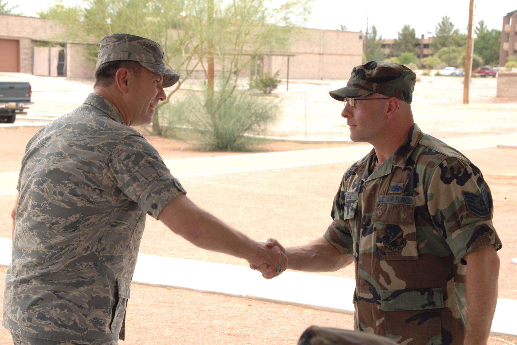 Tech. Sgt. Sean Paquet, 49th Maintenance Group, receives a coin from Col. GeorgeTorres, 49 MXG commander, during the Keep America Beautiful wrap up June 27 at Holloman Air Force Base, N.M. (U.S. Air Force photo/Airman 1st Class Jamal D. Sutter)