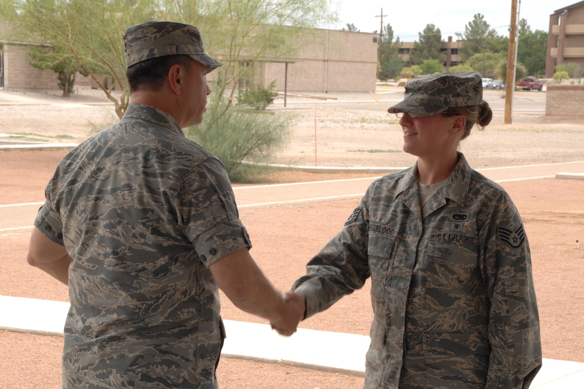 Staff Sgt. Ashley Youngblood, 49th Maintenance Squadron, receives a coin from Col. GeorgeTorres, 49th Maintenance Group commander, during the Keep America Beautiful wrap up June 27 at Holloman Air Force Base, N.M. (U.S. Air Force photo/Airman 1st Class Jamal D. Sutter)