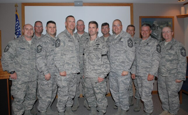 MINOT AIR FORCE BASE, N.D. -- Col. Greg Bell, 5th Bomb Wing vice commander, poses with members of the Minot Chief's Group here after being inducted as an honorary member of the group July 25. The prestigious induction is reserved for commissioned officers who show tremendous support for enlisted members. The officer must be nominated by a member of the chief's group and receive a majority vote to be inducted. (U.S. Air Force photo by Maj. Elizabeth Ortiz) 