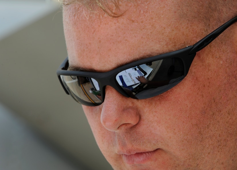 MOODY AIR FORCE BASE, Ga. -- Staff Sgt. Bryan Roy, 23rd Aircraft Maintenance Squadron A-10C Thunderbolt II crew chief, reads from a condensed technical order known as a job guide here July 25. The job guide is a  step by step instruction booklet used by mechanics while working on the A-10C aircraft. (U.S. Air Force photo by Airman 1st Class Brittany Barker)
