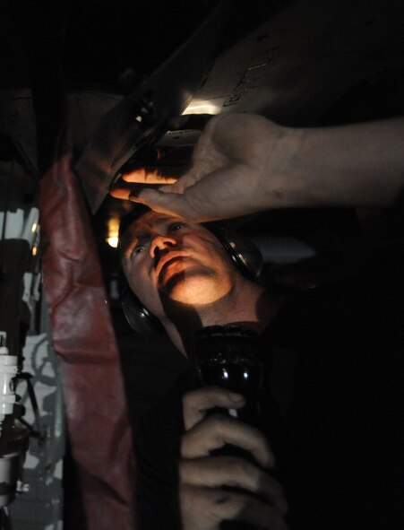 MOODY AIR FORCE BASE, Ga. -- Senior Airman Chase McClung, 23rd Aircraft Maintenance Squadron load crew member, inspects under a panel on a A-10C Thunderbolt II during end of runway checks here July 25. End of runway checks are done to dearm the aircraft and for a final look-over before taxing back to parking locations. (U.S. Air Force photo by Senior Airman Gina Chiaverotti)