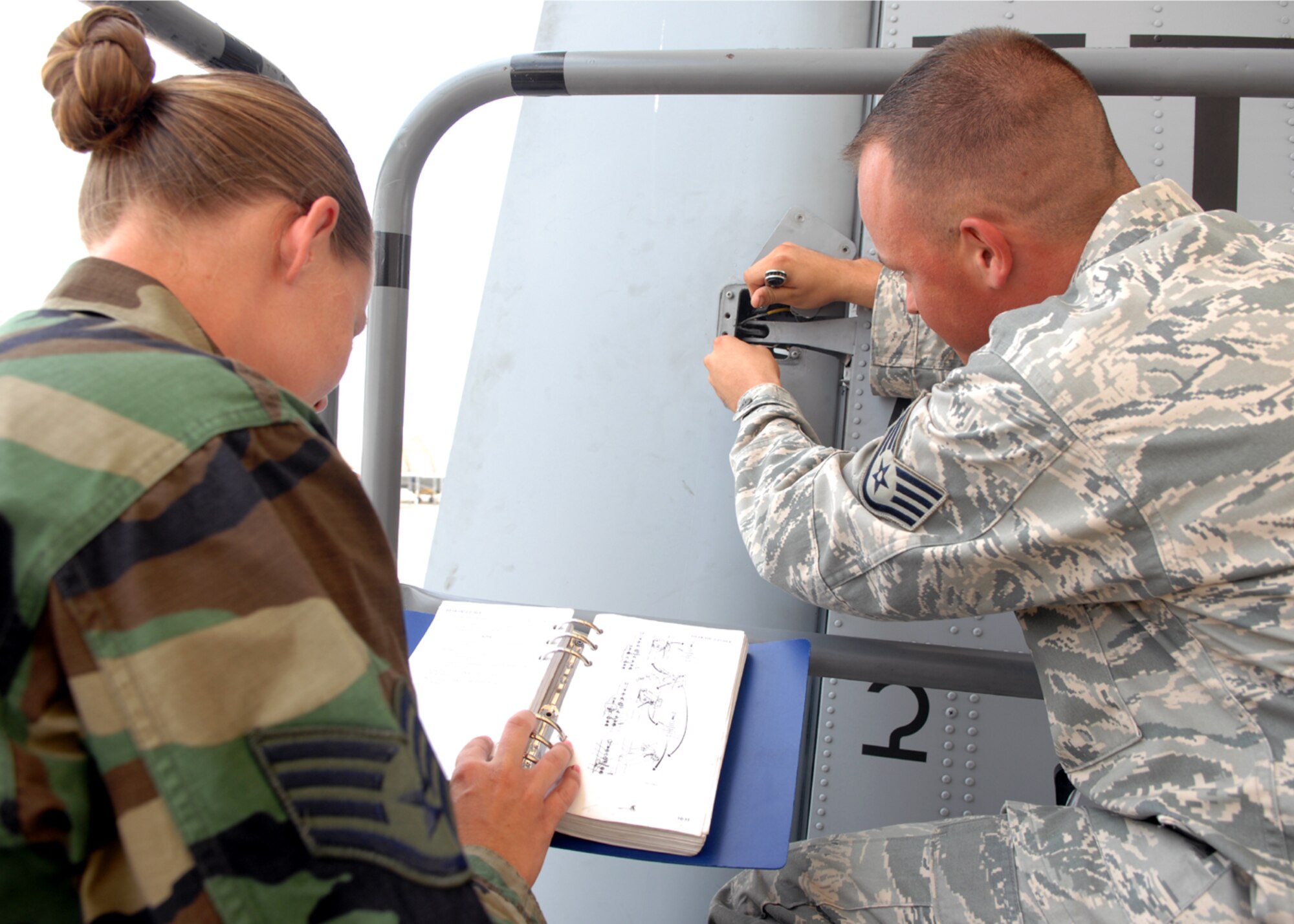 MOODY AIR FORCE BASE, Ga. – Staff Sgt. Rebecca Paz and Staff Sgt. David Clifford, 23rd Aircraft Maintenance Squadron crew chiefs, fix a rudder on an A-10C Thunderbolt II July 25 here. Sergeant Paz helps Sergeant Clifford by giving him step-by-step directions using a maintenance guide. (U.S. Air Force photo by Airman Joshua Green) 


