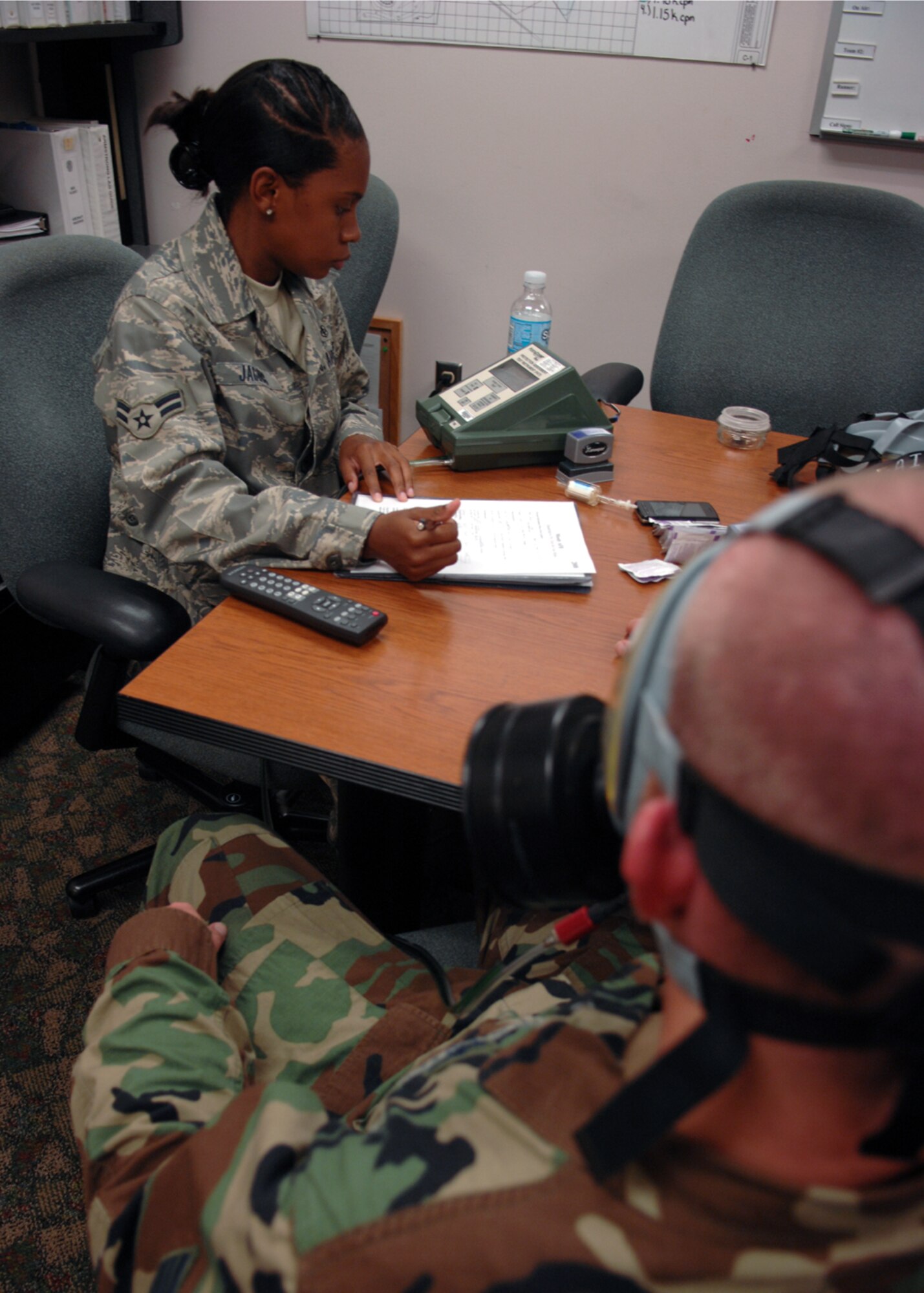 MOODY AIR FORCE BASE, Ga. – Airman 1st Class Janese Jacobs, 23rd Aero Medical Dental Squadron bio-environmental technician, monitors Staff Sgt. Jason Trapp, 23rd Logistics Readiness Squadron material management craftsman, breathing during a gas-mask fitting July 23 here. Airman Jacobs tests gas masks for biochemical warfare by putting Airmen through different types of breathing techniques to ensure the mask is mission ready. (U.S. Air Force photo by Airman Joshua Green)      