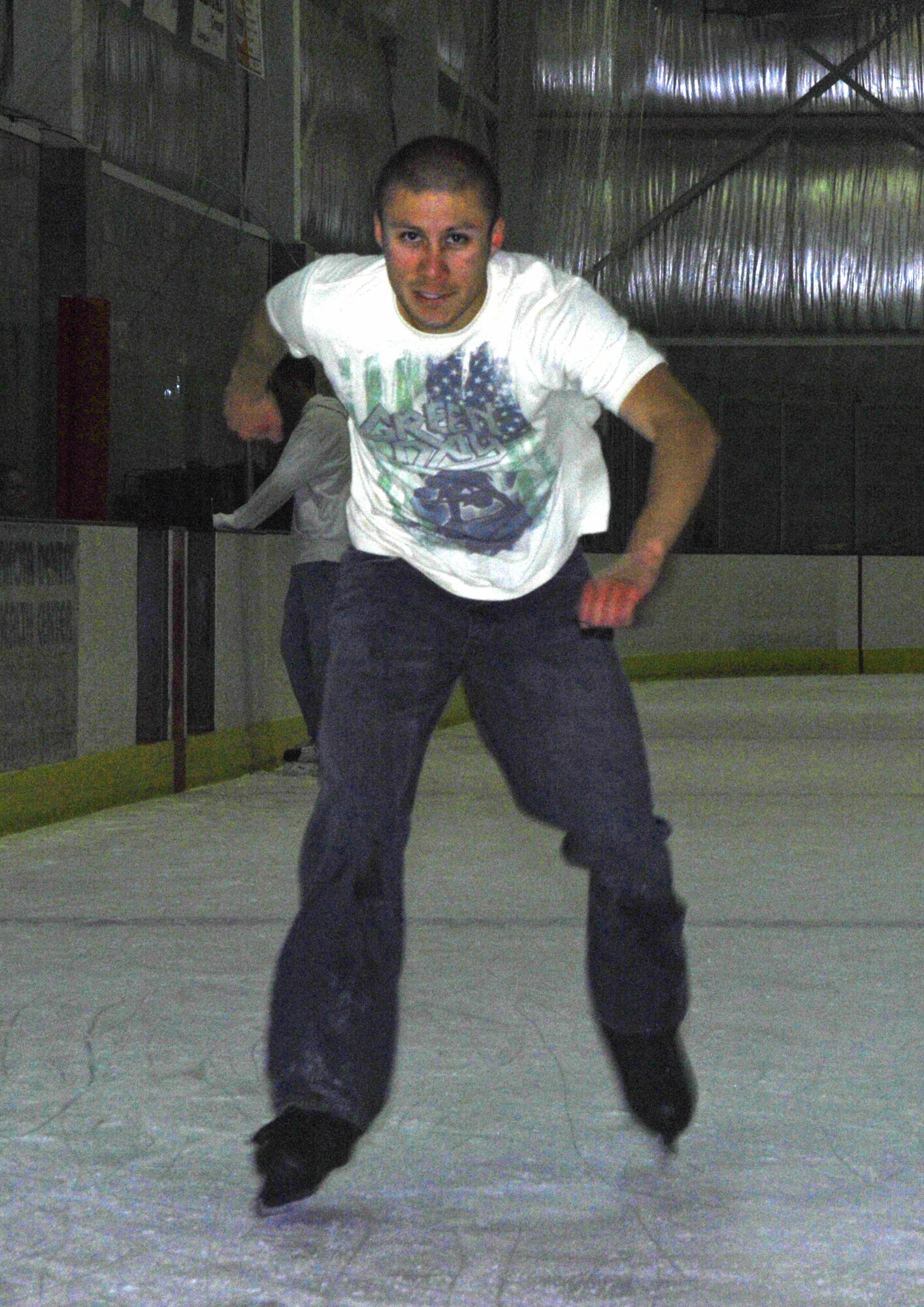 MINOT, N.D. – Senior Airman Aaron Toledo, 5th Communications Squadron network infrastructure technician, tests his abilities as he speeds along the straight away at the West Rink in the Maysa Arena in Minot, N.D. Warbirds and Rough Riders alike escaped the heat and enjoyed an afternoon of ice skating July 27. The group of Airmen gather together every Sunday for open skating from 3 p.m. to 6 p.m. and enjoy a casual meal afterward. (U.S. Air Force photo by Airman 1st Class Benjamin Stratton)