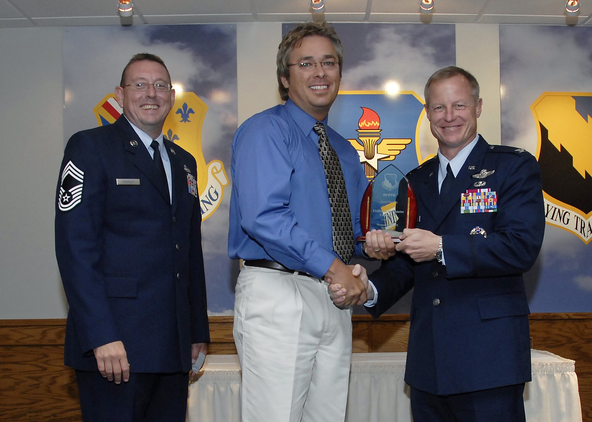David Bowles, center, accepts the Category III Civilian of the Quarter award from 80th Flying Training Wing Commander David Petersen July 22 at the wing's quarterly awards banquet. Also pictured is wing Superintendent Chief Master Sgt. Norman Thierolf. (U.S. Air Force photo/Mike Litteken)