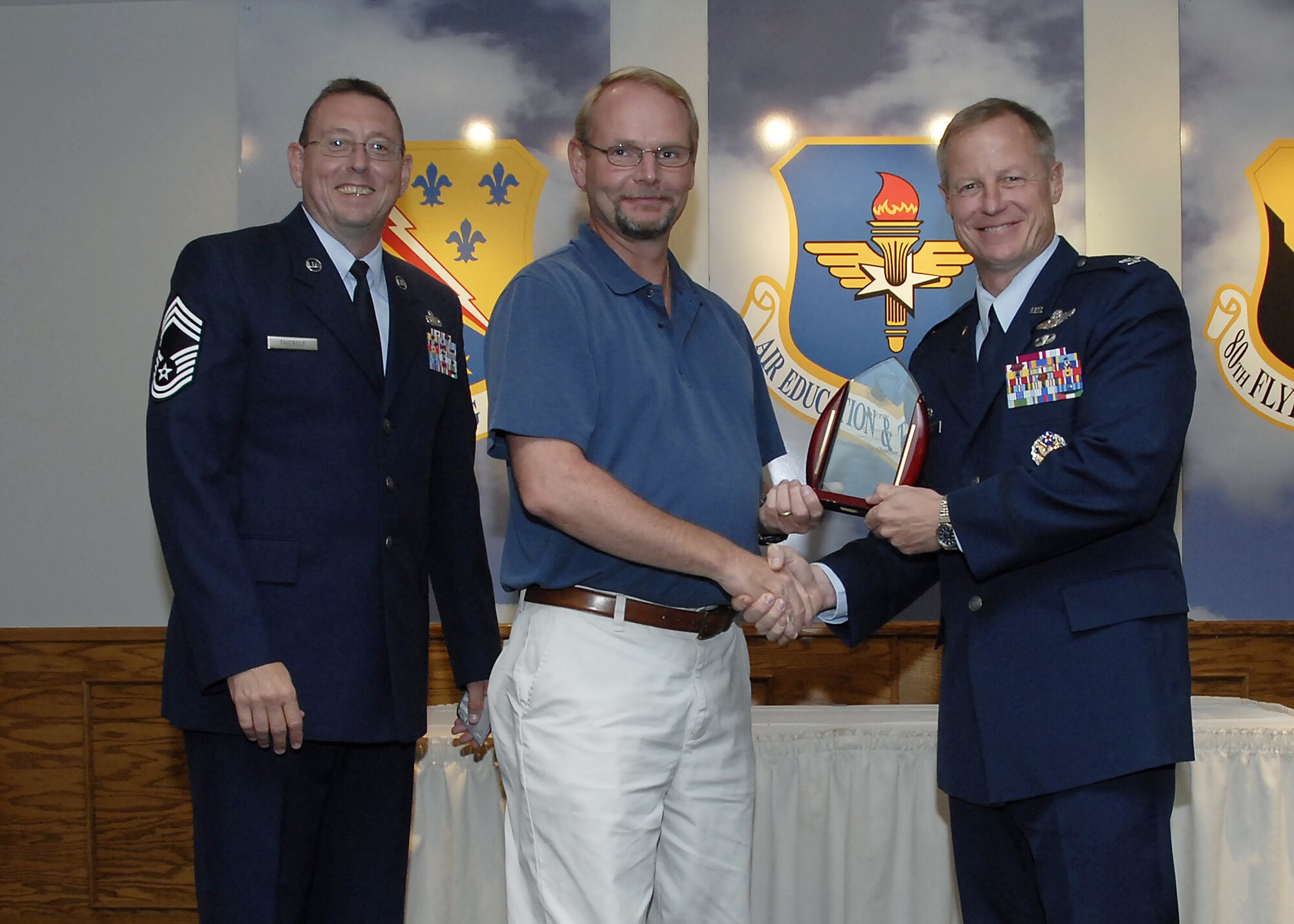Klaus Lammers, center, accepts the Category II Civilian of the Quarter award from 80th Flying Training Wing Commander David Petersen July 22 at the wing's quarterly awards banquet. Also pictured is wing Superintendent Chief Master Sgt. Norman Thierolf. (U.S. Air Force photo/Mike Litteken)