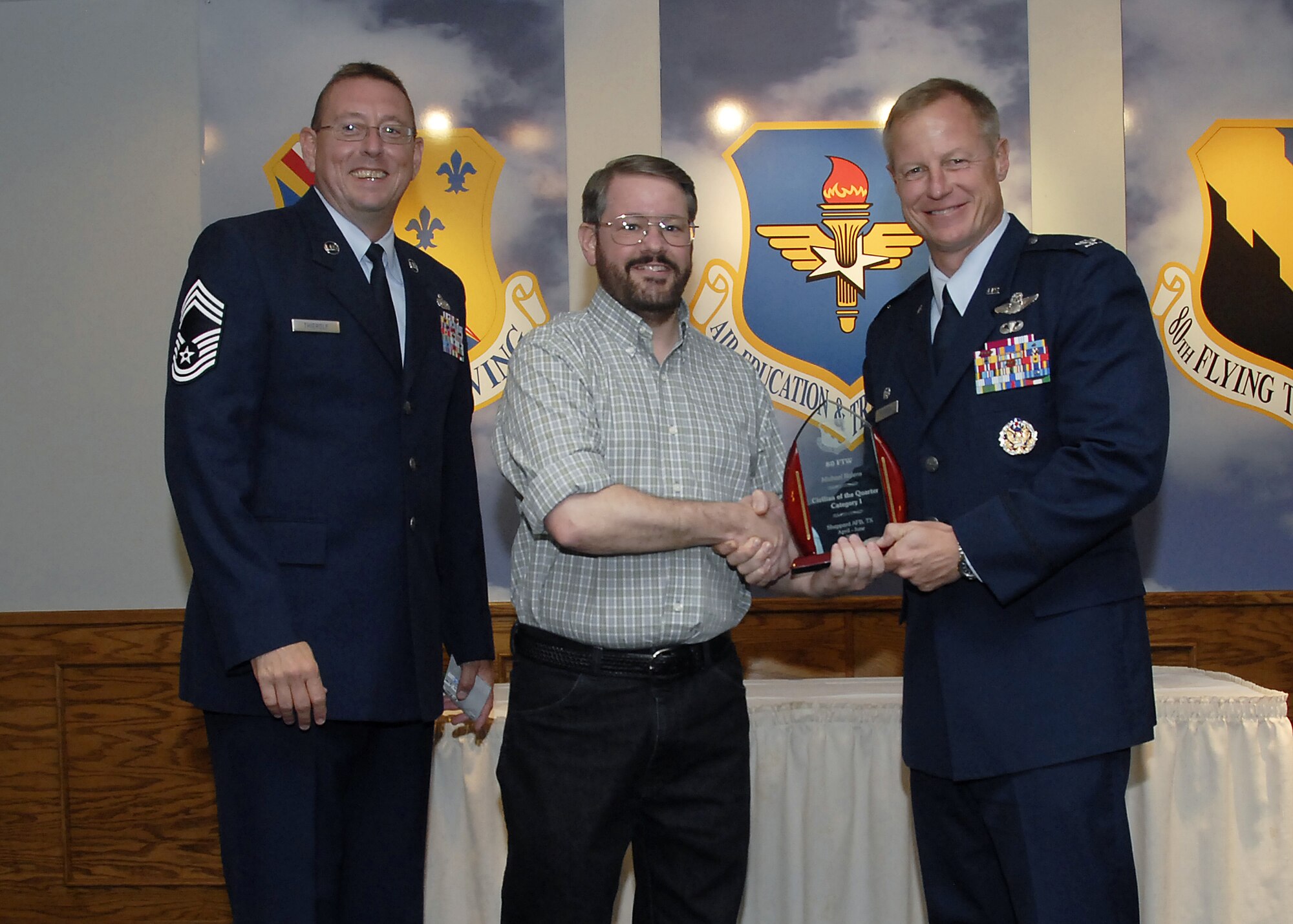 Michael Rolens, center, accepts the Category I Civilian of the Quarter award from 80th Flying Training Wing Commander David Petersen July 22 at the wing's quarterly awards banquet. Also pictured is wing Superintendent Chief Master Sgt. Norman Thierolf. (U.S. Air Force photo/Mike Litteken)