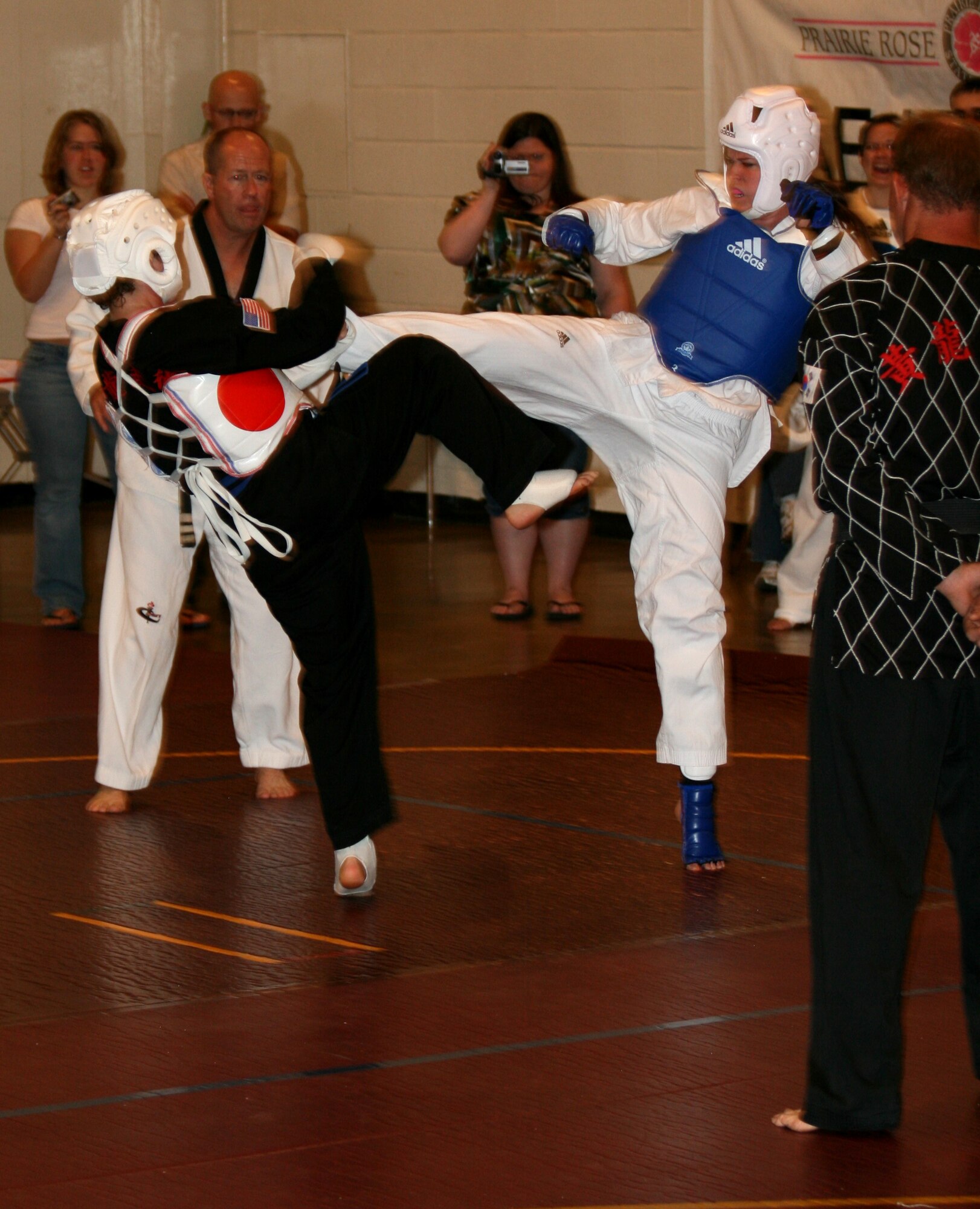 MINOT AIR FORCE BASE, N.D. – Capt. Kera Averill, 23rd Bomb Squadron electronics warfare officer, delivers a powerful sidekick sending her opponent stumbling to the ground during the North Dakota Prairie Rose Games in Minot July 12. Captain Averill is a Tae Kwon Do white-belt. During the competition, she claimed gold and silver awards. (U.S. Air Force photo by Master Sgt. Ron Tolzin) 