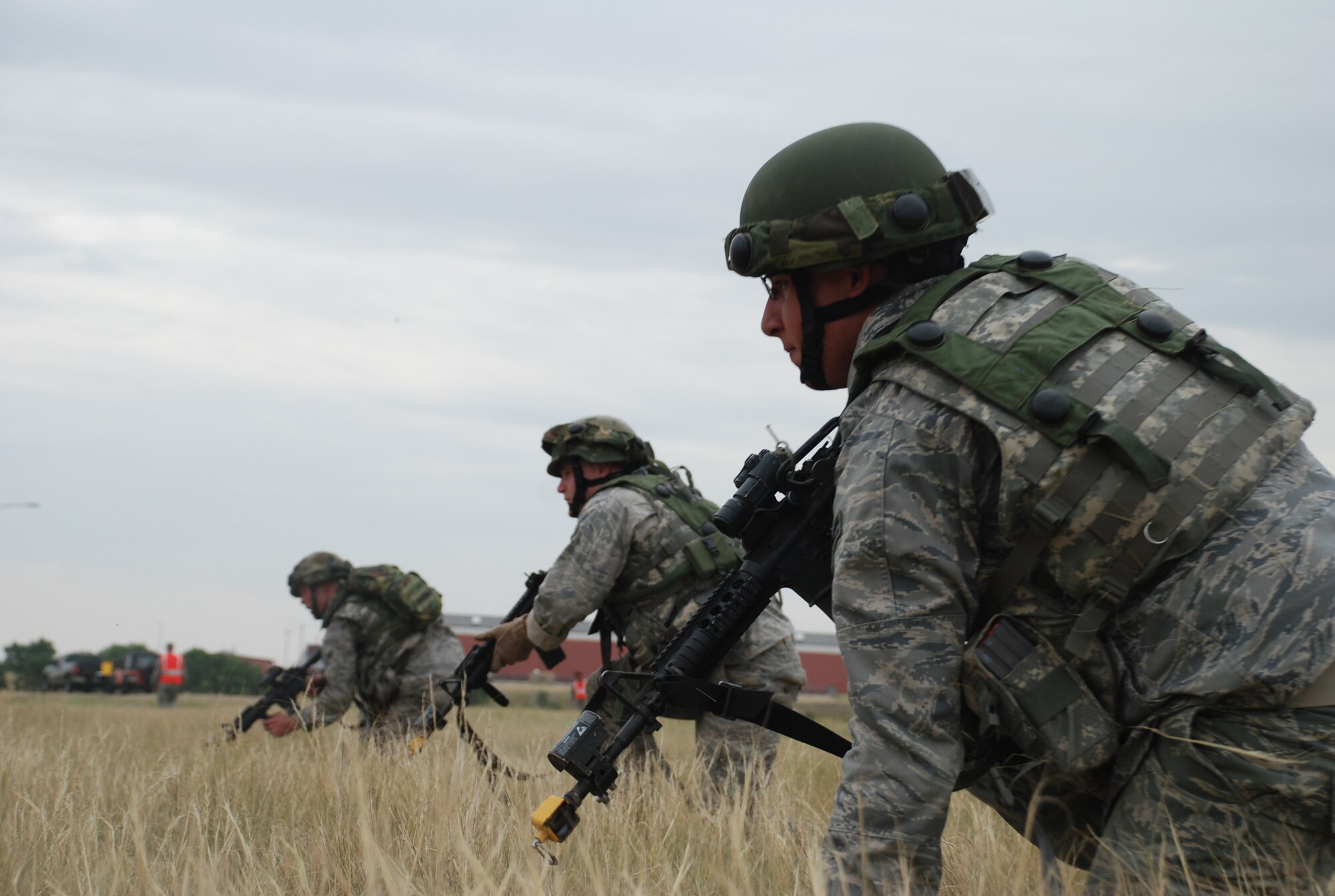 Airman 1st Class Caesar Montalvo, 790th Missile Security Forces Squadron, and his wingman advance on mock opposing forces during the force on force training.
