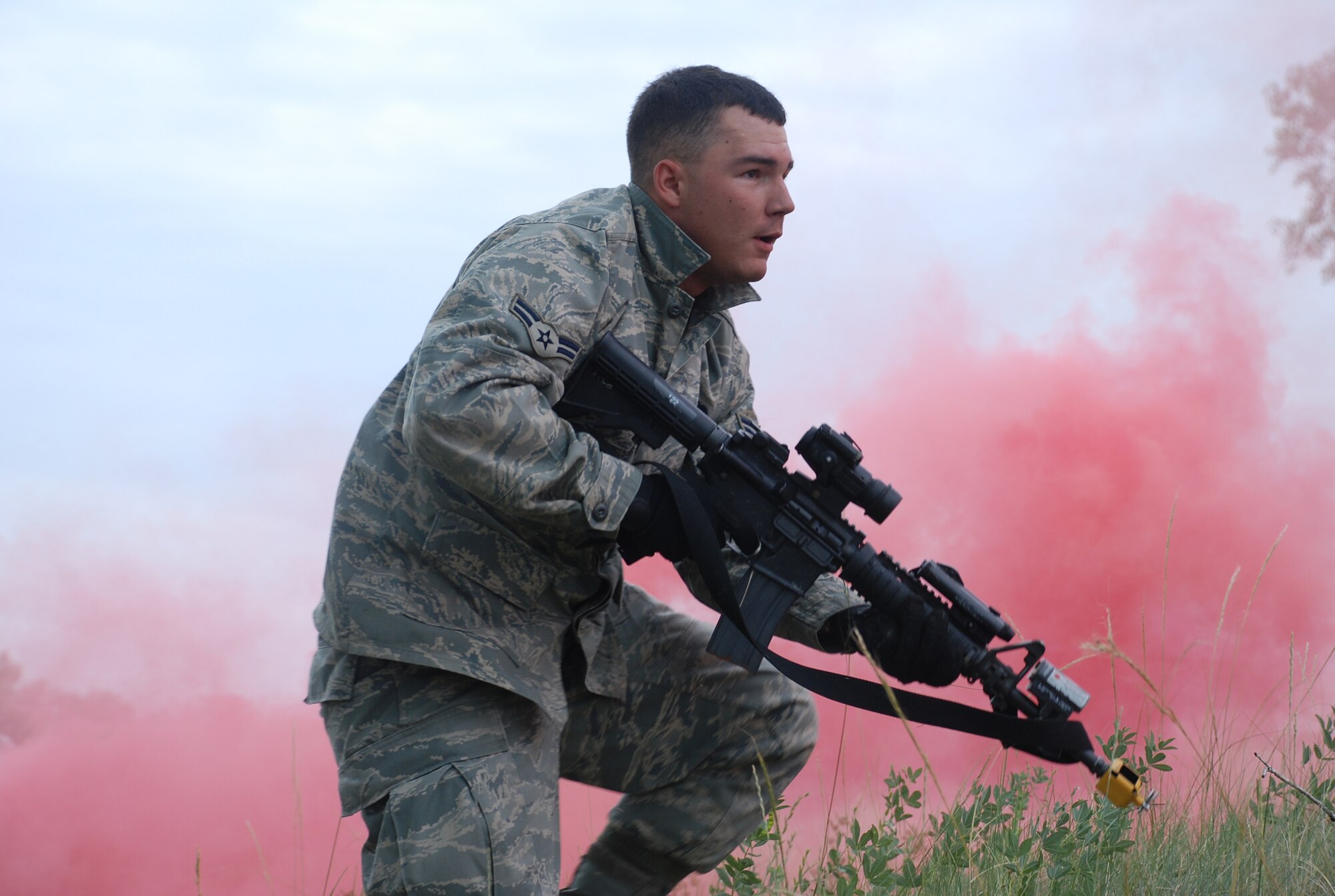 Airman 1st Class Carlton Jefferson, 90th Missile Security Forces Squadron, runs toward practicing security forces members as a mock enemy sniper during a force on force training secession July 17. The annual training is intended to challenge security forces Airmen with real-world scenarios (Photos by Airman 1st Class Alex Martinez).