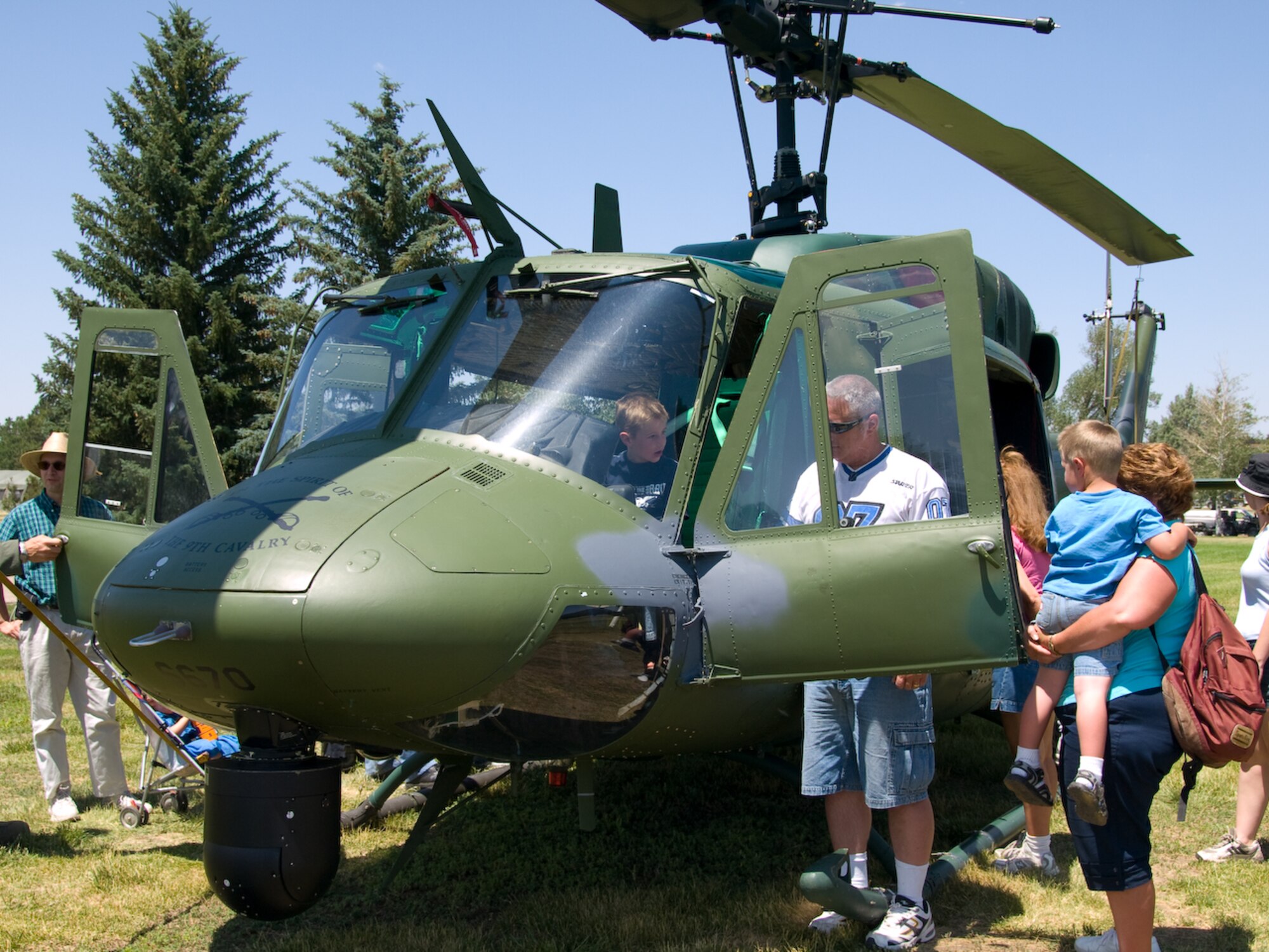 Visitors observe one of the 37th Helicopter Squadron's UH-1N Iroquois "Huey" helicopters (Photo by Capt. Randall Deppensmith).