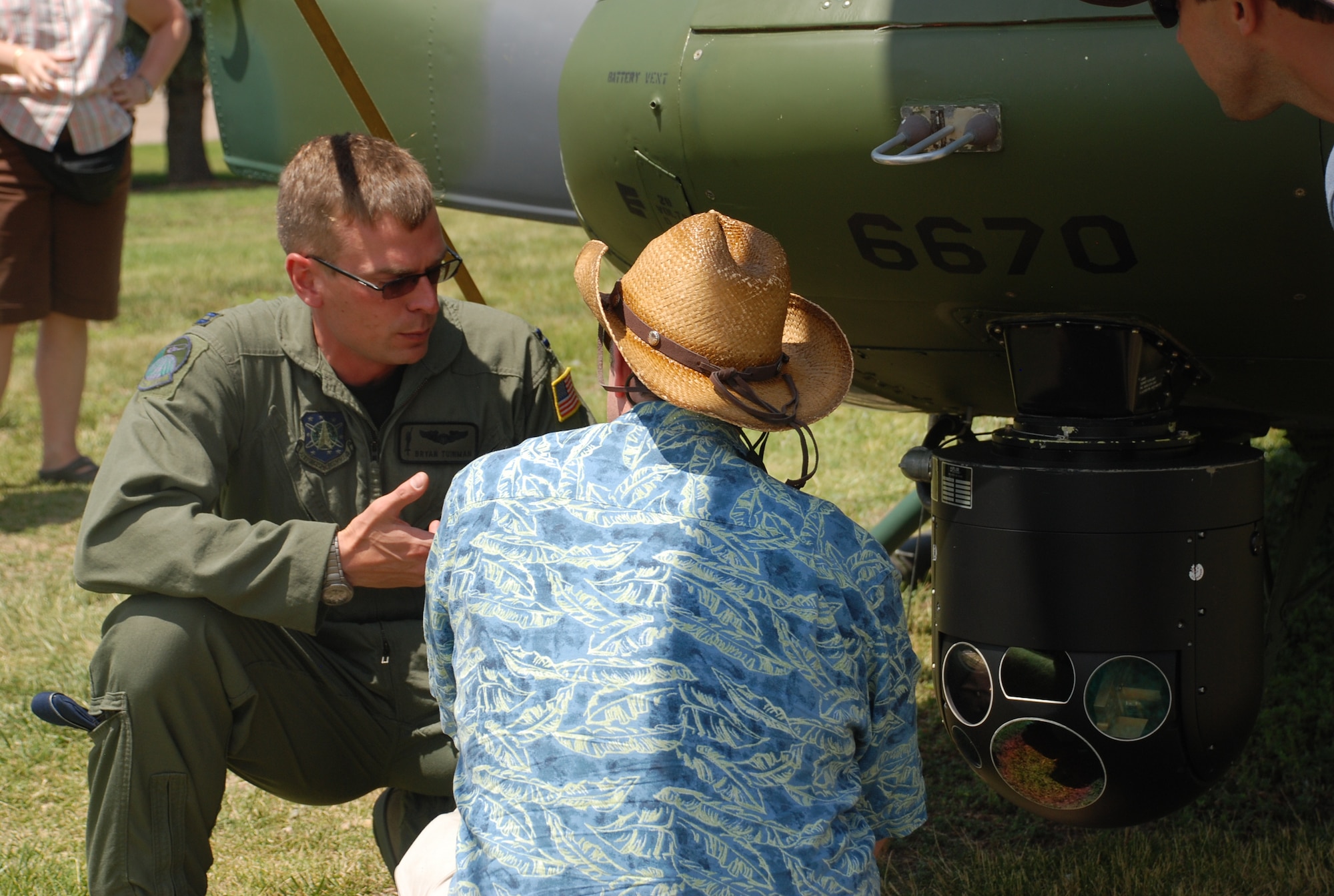 Capt. Bryan Tuinman, 37th Helicopter Squadron, explains helicopter components to a Fort D.A. Russell Days visitor July 18. The 37th HS offered a static display of one of its UH-1N Iroquois or “Huey” (Photo by Senior Airman Connor Burkhard).