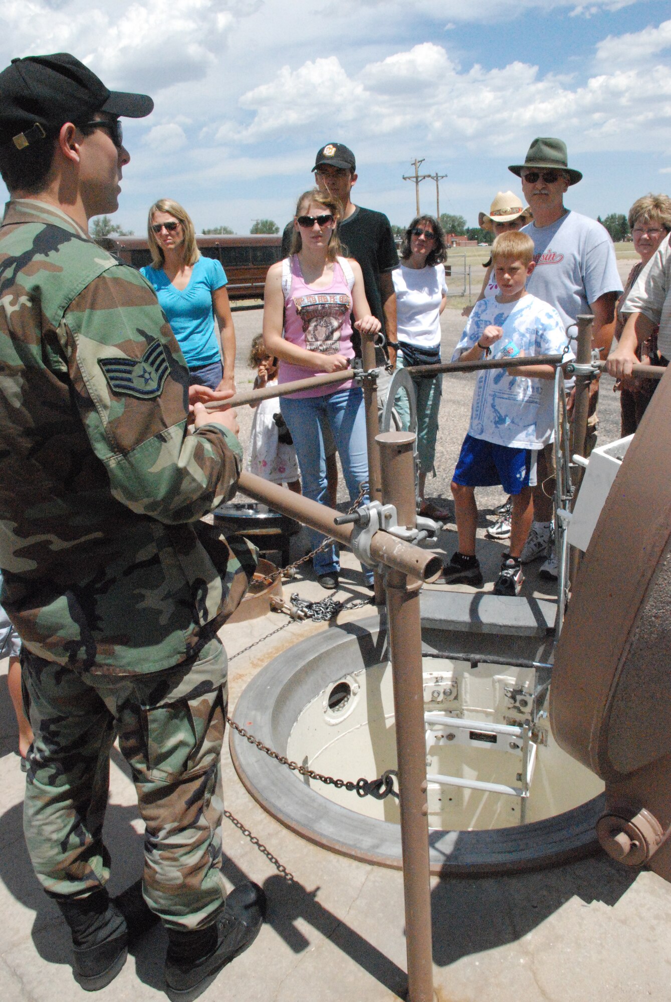 Staff Sgt. Daniel Weisz, 90th Maintenance Operations Squadron, explains how maintainers enter and exit a launch facility using the mock LF, U-01, on base July 20 (Photo by 1st Lt. Lisa Meiman). 