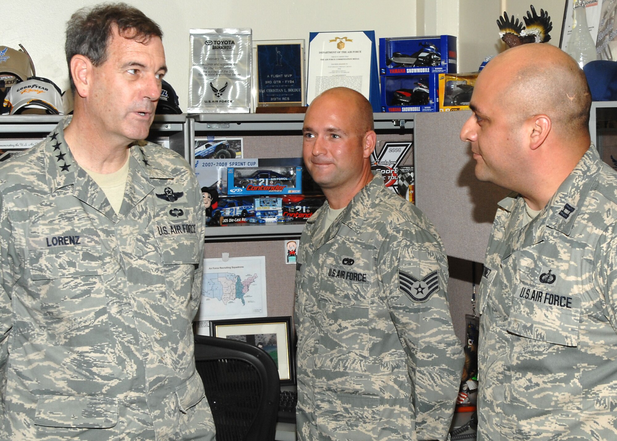 Gen. Stephen R. Lorenz speaks with Capt. Homero Martinez, right, and Staff Sgt. Christian Bolduc, center, July 25 during a tour of Headquarters Air Force Recruiting Service at Randolph Air Force Base, Texas. The Air Force Recruiting Service Events Marketing Branch chief and motor sports NCO were among several AFRS members on hand to talk about recruiter support with the commander of Air Education and Training Command. The visit marked the first AFRS tour by the major command leader since he assumed command July 2. (U.S. Air Force photo/Joel Martinez)