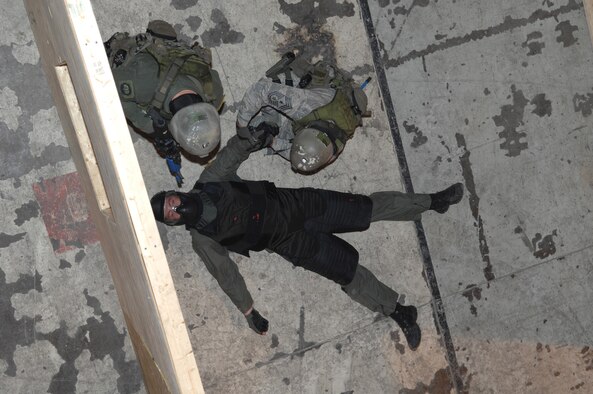 MINOT AIR FORCE BASE, N.D. -- Chief Master Sgt. David Spector (top right), 20th Air Force command chief, and Senior Airman Cody Chick, 791st Missile Security Forces Squadron response force leader, search “adversary” Senior Airman Jonathan Flood, also a response force leader  from the 791st MSFS, during a training exercise here July 28. Chief Spector participated in the recapture/recovery exercise as part of his visit to the 791st MSFS tactical response force training facility. (U.S. Air Force photo by Senior Airman Cassandra Jones)