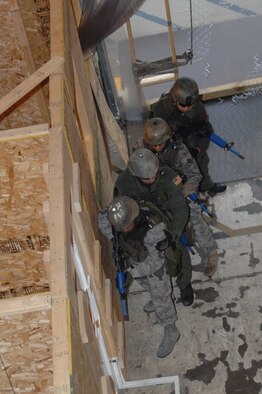 MINOT AIR FORCE BASE, N.D. -- Chief Master Sgt. David Spector, 20th Air Force command chief, receives a tap on the arm from Senior Airman Cody Chick, a response force leader from the 791st Missile Security Forces Squadron, signaling the team is ready to enter the training area during a training exercise here July 28. Chief Spector participated in the recapture/recovery exercise as part of his visit to the 791st MSFS tactical response force training facility. (U.S. Air Force photo by Senior Airman Cassandra Jones)