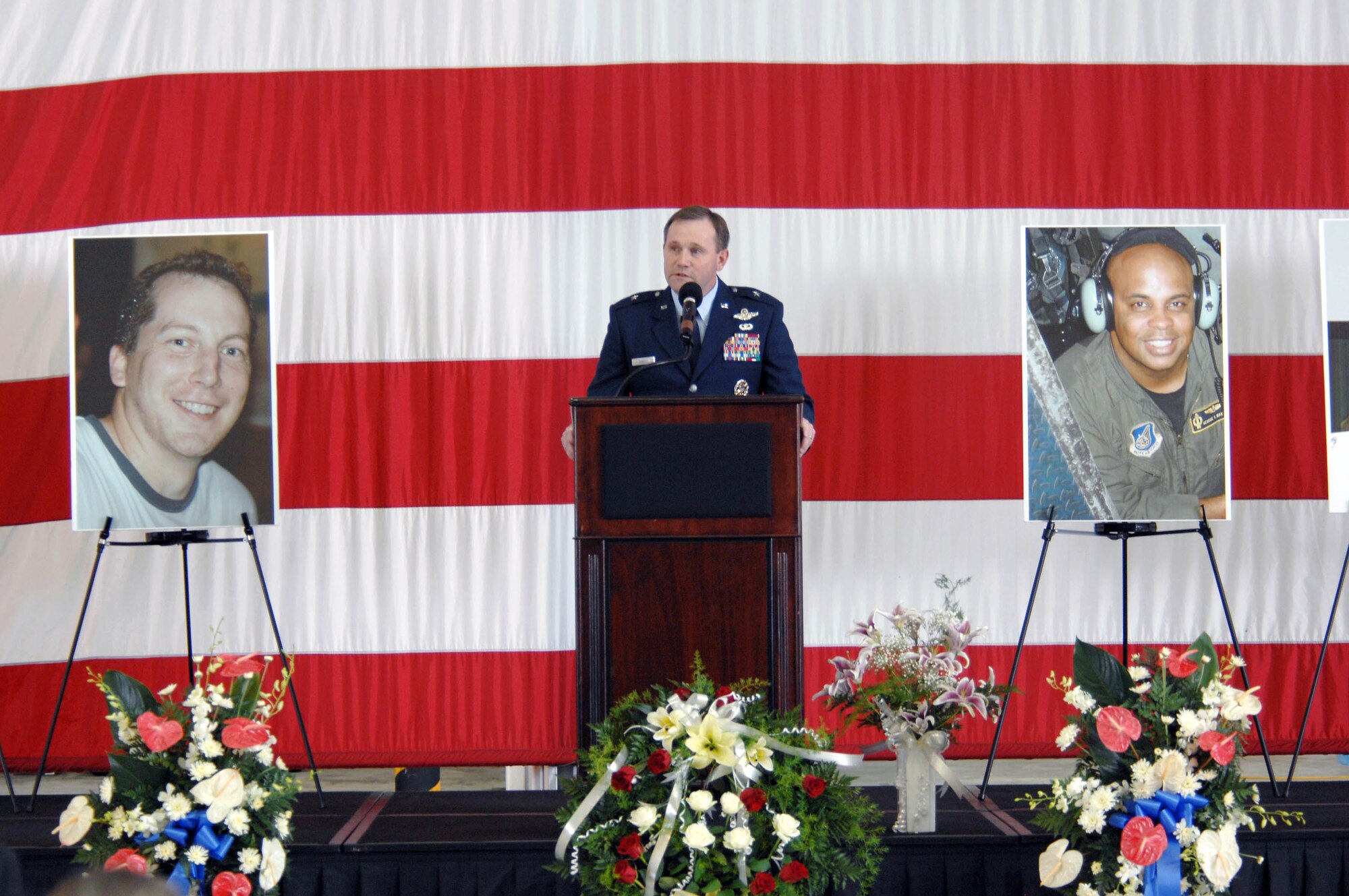 Brig. Gen. Doug Owens, 36th Wing commander, delivers a heartfelt message to more than 1,800 guests who attended a memorial ceremony July 25 at Andersen's Hangar One. The ceremony honored the six Airmen who died when their B-52 crashed July 21, 25 miles off the coast of Guam. Their mission was to flyover Guam's Liberation Day parade celebrating the island's liberation from Japanese occupation in World War II. (U.S. Air Force photo/Airman 1st Class Corey Todd)