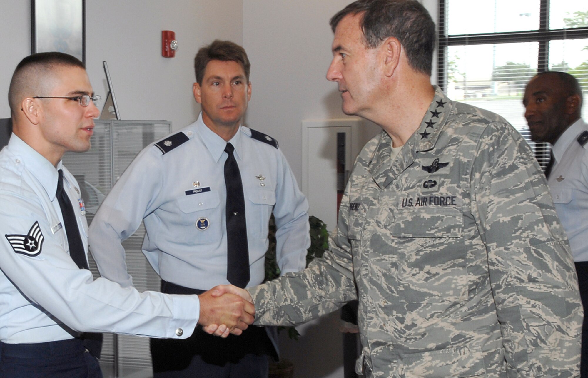 Staff Sgt. Russell Van Brenden, left, and Lt. Col. John E. Poast III, center, greet Gen. Stephen R. Lorenz in the Live Oak recruiting office in Texas July 25. The 341st Recruiting Squadron enlisted accessions recruiter and commander were among several Air Force Recruiting Service members on hand to show the commander of Air Education and Training Command the prototype office. The facility features the new standard for office size, furnishings and interior design. The visit marked the first AFRS tour by the major command leader since he assumed command July 2. (U.S. Air Force photo/Joel Martinez)