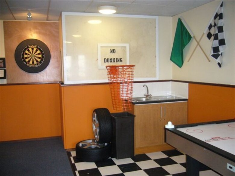 A basketball hoop provides an incentive to put trash where it belongs in the new Sports Den created as part of the newly dedicated 423rd Air Base Group Dormitory renovation and morale project. The Sports Den was created by Dorm Manager Air Force Technical Sgt. Phillip Allen. (U.S. Air Force photo by Technical Sgt. Phillip A. Allen) 