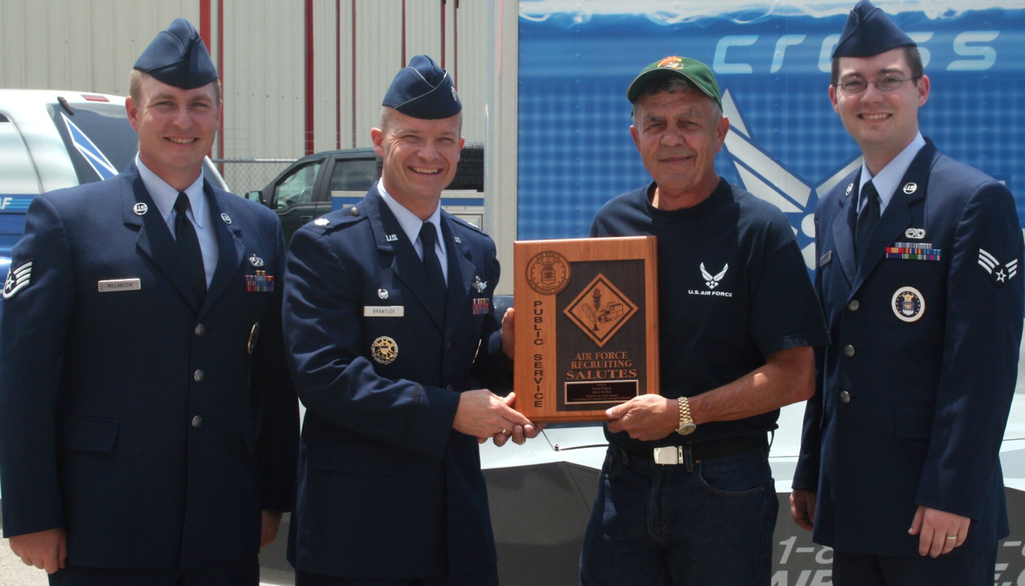 Lt. Col. Mike Brantley presents Louis Dupuy the Air Force Recruiting Salutes award July 14 in Lafayette, La. The 331st Recruiting Squadron commander and local area recruiters Staff Sgt. Darryl Melancon, left, and Senior Airman Andrew Saylor, right, recognized the local business owner for providing exceptional public service and support to the Air Force recruiting mission. (Photo courtesy of Lyndsay Melancon)
