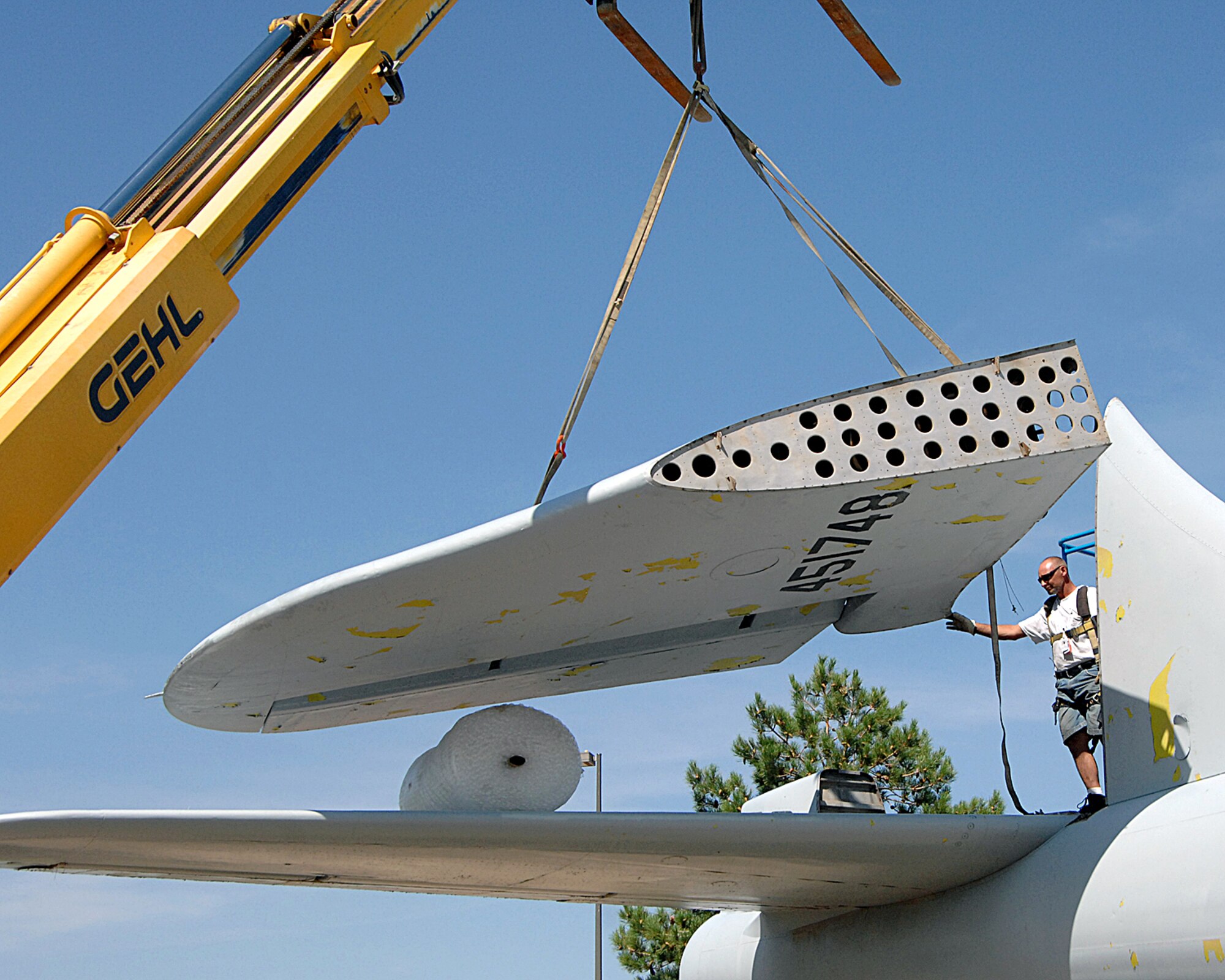Workers help a crane situate part of the B-29 bomber which will be housed in the new National Museum for Nuclear Science and History under contruction near Eubank Boulevard and Southern Street, about 2 miles from Kirtland AFB.  The aircraft has been on display at the old Atomic Museum location on Wyoming Boulevard across from 377th Air Base Wing headquarters.  U.S. Air Force photo by Helga Carter