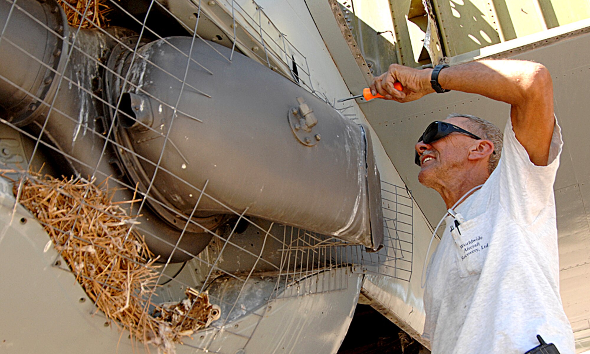 A worker takes apart the World War II B-29 bomber which will be housed in the new National Museum for Nuclear Science and History under contruction near Eubank Boulevard and Southern Street, about 2 miles from Kirtland AFB.  The aircraft has been on display at the old Atomic Museum location on Wyoming Boulevard across from 377th Air Base Wing headquarters.  U.S. Air Force photo by Helga Carter