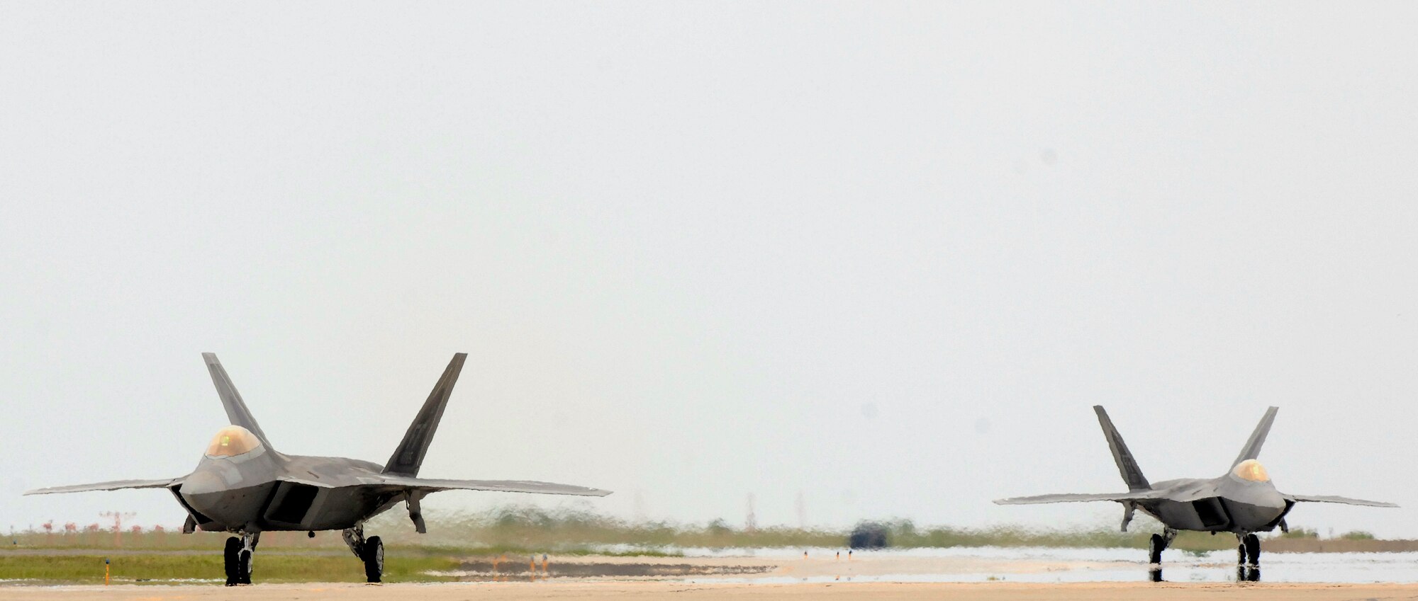 LANGLEY AIR FORCE BASE, Va. -- Two F-22A Raptors from the 94th Fighter Squadron return to Langley July 25 after participating in Combat Archer held at Tyndall Air Force Base, Fla.   Combat Archer is an air-to-air system evaluation in which pilots test the reliability and effectiveness data of aircraft and missiles and completed required training for their Air Expeditionary Force cycle.   (U.S. Air Force photo/Senior Airman Vernon Young)