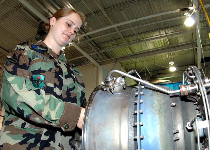 Senior Airman Marie R. Warren, 58th Maintenance Squadron, works on an engine in the engine Queen Bee (propulsion shop). Airman Warren recently received a First Degree Black Belt in Shao-Lin  Kung Fu. U.S. Air Force photo by Damian Bohannon