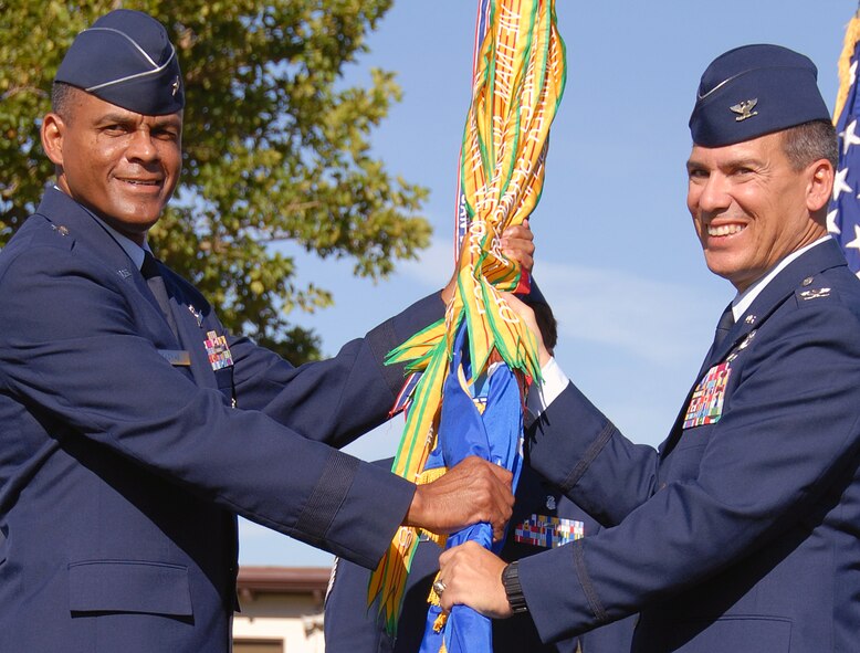 At the 377th Air Base Wing Change of Command Ceremony held at Hardin Field here July 22, Air Force Nuclear Weapons Center Commander Brig. Gen. Everett Thomas, left, transfers command of the 377th ABW to Col. Michael S. Duvall. Colonel Duvall's previous assignment was director, Training and Exercises, U.S. Pacific Command, Camp H.M. Smith, Hawaii. Former Commander Colonel Robert E. Suminsby Jr. departed for Ramstein Air Base, Germany. U.S. Air Force photo by Elizabeth Martinez 
