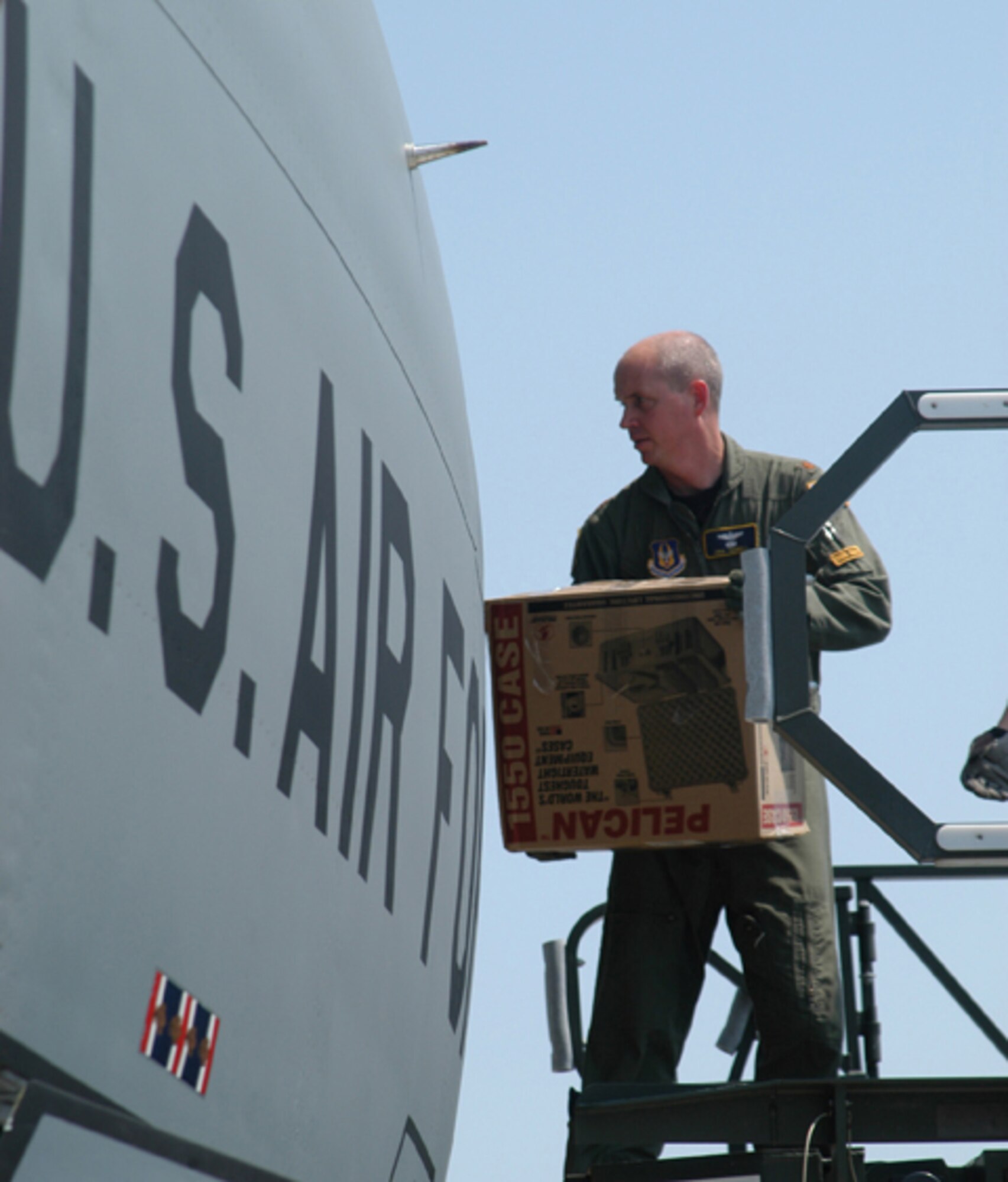 GRISSOM AIR RESERVE BASE, Ind., -- Maj. Erik Thorell, a KC-135 pilot, helps to load equipment from Purdue University aboard the aircraft in preparation for a trip to Greenland.  The 434th Air Refueling Wing provided transportation for a 13-person research team that included members from Purdue's physics and nuclear engineering departments, Air Force ROTC and the Air Force Academy. (U.S. Air Force photo/Lt. Col. Gary Lockard)                                