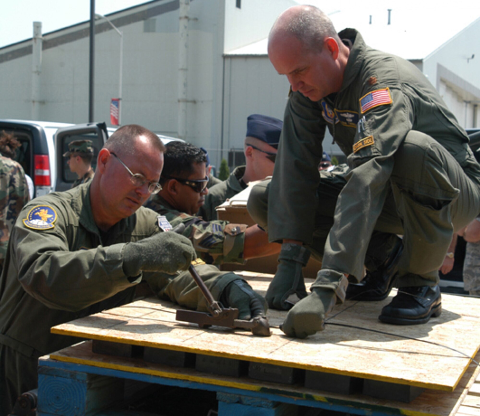 GRISSOM AIR RESERVE BASE, Ind., --  Master Sgt. Scott Ward (left), inflight refueling technician, and Maj. Erik Thorell, KC-135 pilot, prepare a cargo pallet for use in transporting research equipment to Greenland.  The 434th Air Refueling Wing provided transportation for a 13-person research team to Thule Air Base.  While in Greenland, the team will conduct scientific experiments dealing with the sun and its' effect on communications systems.  (U.S. Air Force photo/Lt. Col. Gary Lockard)                          