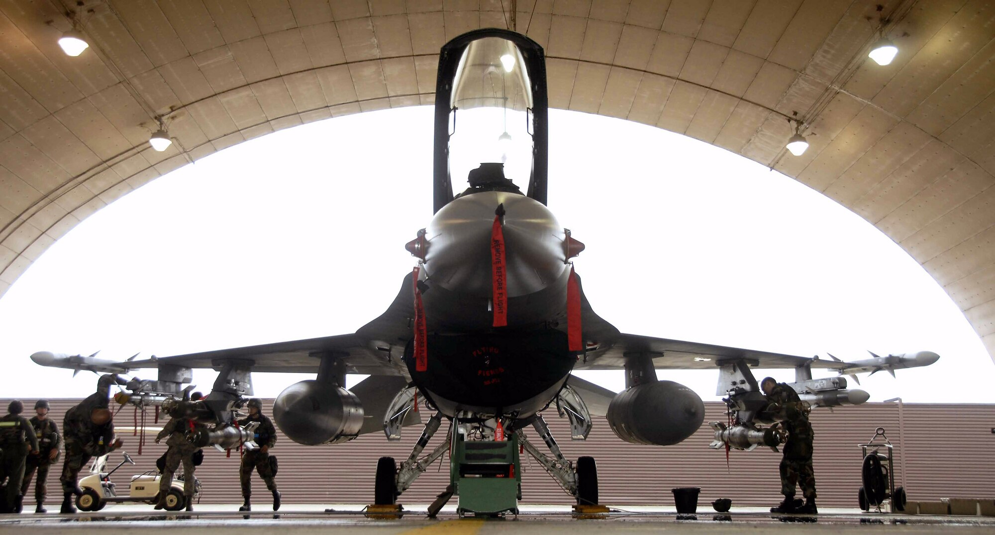 Airmen prepare an F-16 Fighting Falcon aircraft for an upcoming mission during a base-wide exercise July 21 at Osan Air Base, South Korea. The operational readiness exercise tests Osan AB Airmen's ability to execute combat operations, receive follow-on forces and defend the base from attack. (U.S. Air Force photo/Senior Airman Christopher Boitz)
