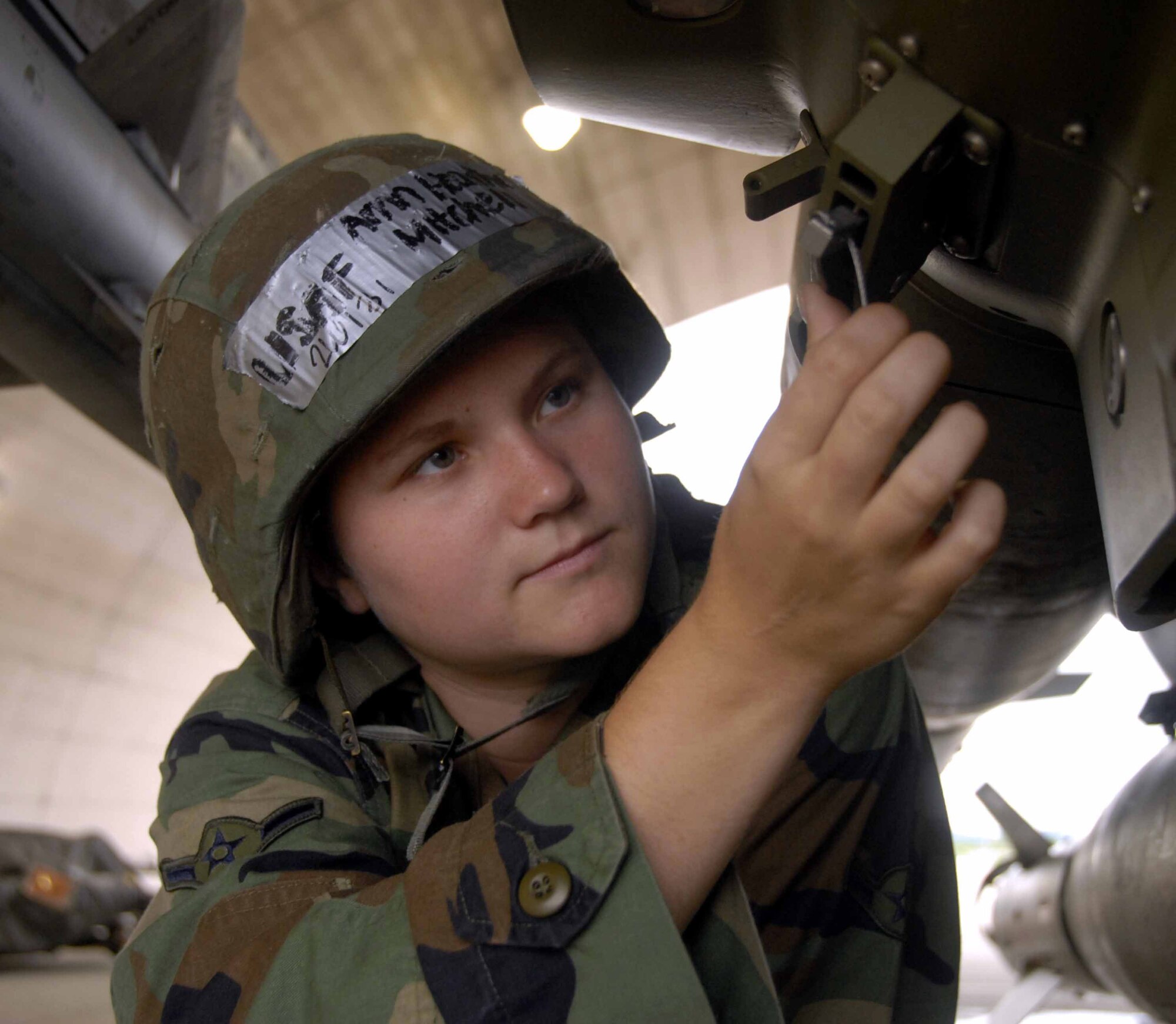 Airman Heather Mitchell checks a wing release wire on a guided bomb unit-12 loaded onto an F-16 Fighting Falcon aircraft during an inspection July 21 at Osan Air Base, South Korea. If the wire is damaged, the weapon will not release properly from the aircraft. Airman Mitchell is a weapons loader with the 51st Aircraft Maintenance Squadron. (U.S. Air Force photo/Senior Airman Christopher Boitz)