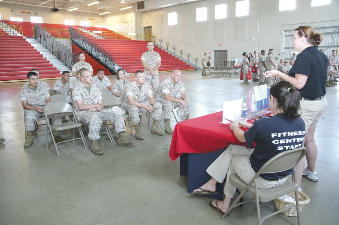 Marines listen in about Fitness and Injury Prevention from Lenora Steele at the Semper Fit Health Education Fair inside of the All-Weather Training Facility.