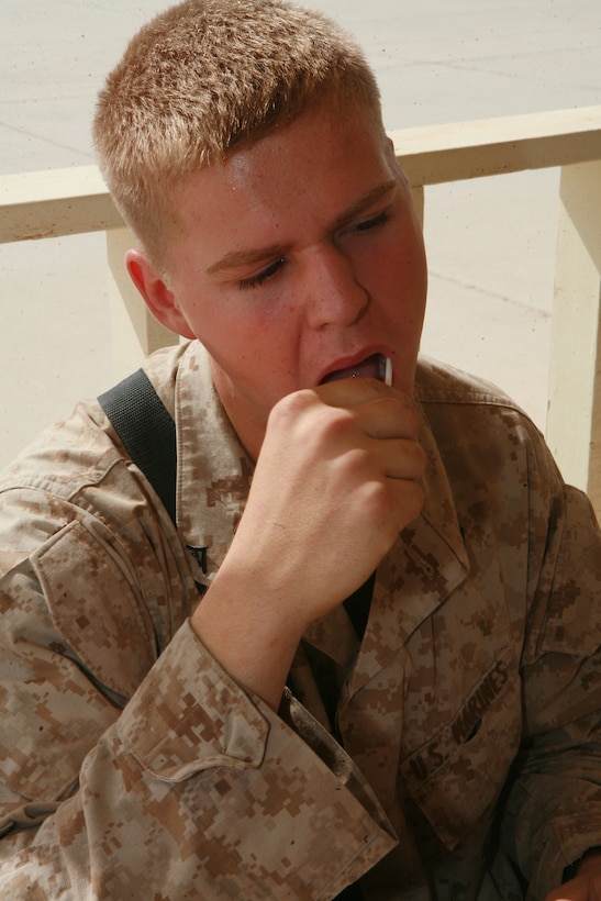 AT-TAQADDUM, Iraq (July 28, 2008) - Lance Cpl. Tom A. Leu, 20, from Clinton, Iowa, a diesel mechanic with Maintenance Company, 1st Supply Battalion (-) (Reinforced), 1st Marine Logistics Group, swabs the inside of his cheek to collect a DNA sample, July 28. Service members and contract civilians donated an oral swab sample to register for the C.W. Bill Young Department of Defense Marrow Donor Program. (Photo by Lance Cpl. Cindy G. Alejandrez)