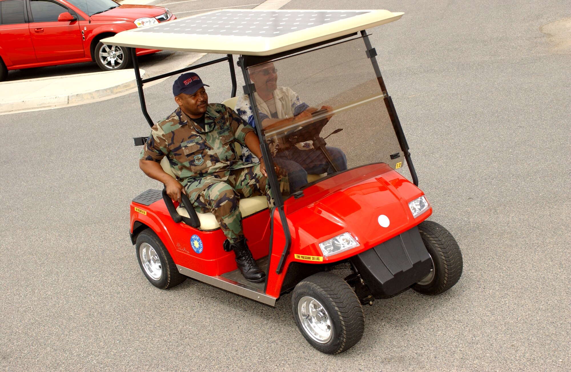 Master Sgt. Cedric Perry (left) and Gerald Haas take a spin on a solar-powered golf cart now being tested by Civil Engineering. Master Sgt. Perry is the Wing’s ground safety specialist and Haas is a pollution prevention management specialist with the 452nd Civil Engineering Squadron at March Air Reserve Base. (U.S. Air Force photo by Senior Airman David K. Flaherty)
