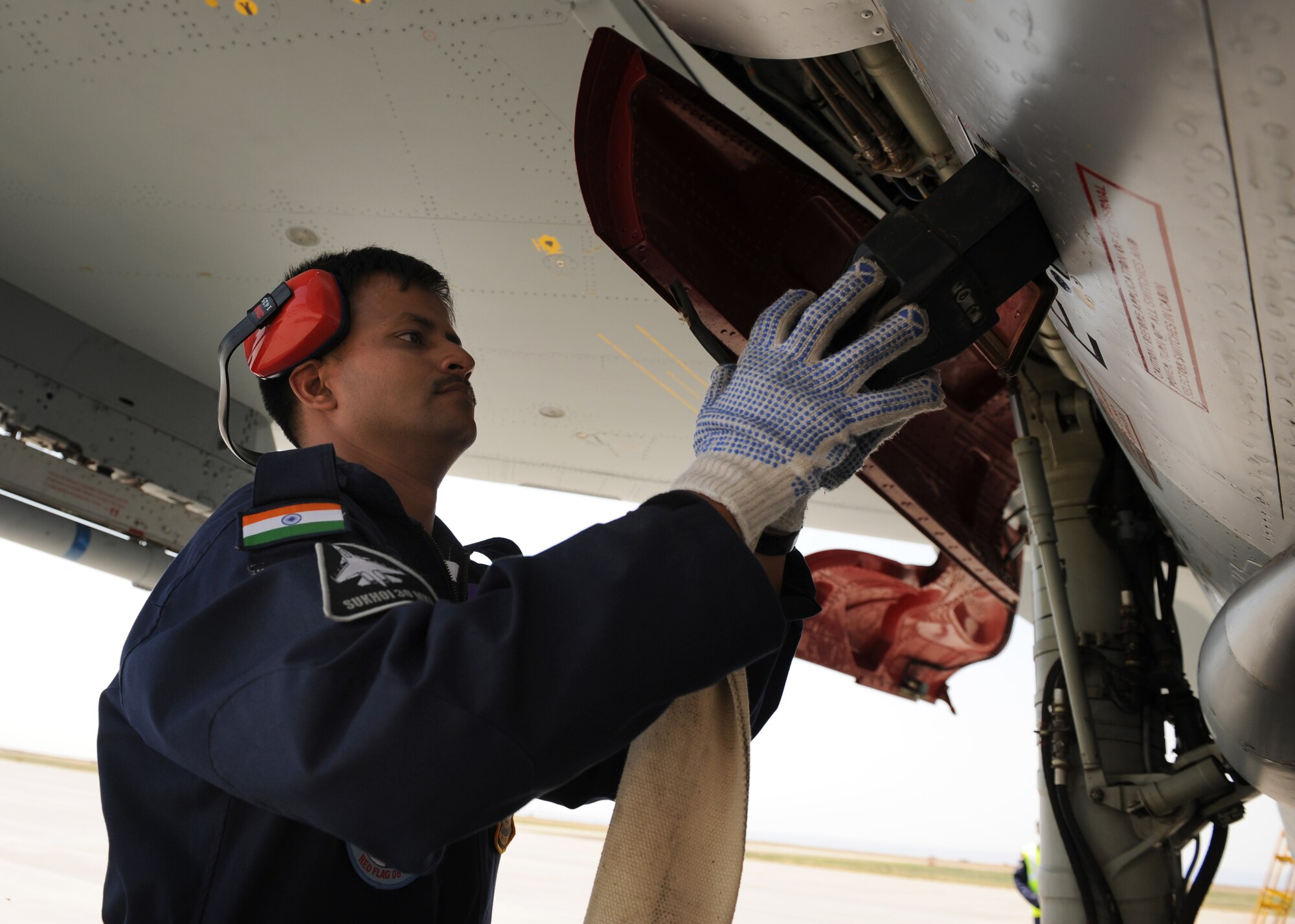 MOUNTAIN HOME AIR FORCE BASE, Idaho -- Indian air force Cpl. David Mewa, IAF maintainer, performs after flight inspections of the Indian air force SU-30 MKI fighter jet after the jet landed at Mountain Home Air Force Base, Idaho, July 25. The IAF is at Mountain Home AFB to train with the Airmen here before participating in Exercise Red Flag at Nellis AFB, Nev., which begins Aug. 9. This is the first time in history the IAF has been on American soil to train with U.S. fighters. They are taking advantage of Mountain Home's vast air space and multiple ranges to better prepare their aircrews for future flying missions. (U.S. Air Force photo/ Airman 1st Class Stephany Miller)