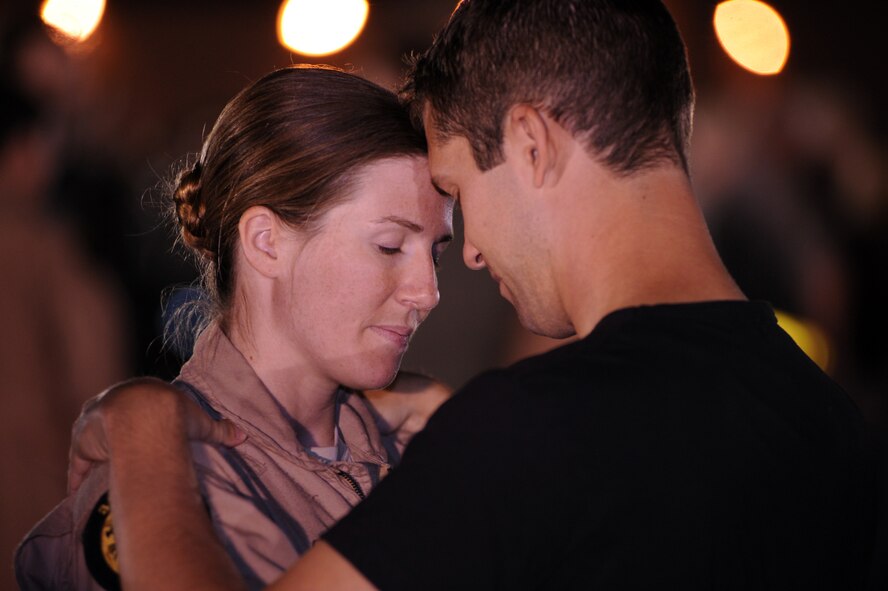 Capt. Robin Prosser, 37th Bomb Squadron pilot, is welcomed back from a six-month deployment in Southwest Asia by her fiance, Damon, July 29. Ellsworth welcomed home approximately 300 Airmen arriving from Southwest Asia. (U.S. Air Force photo/Airman Corey Hook)