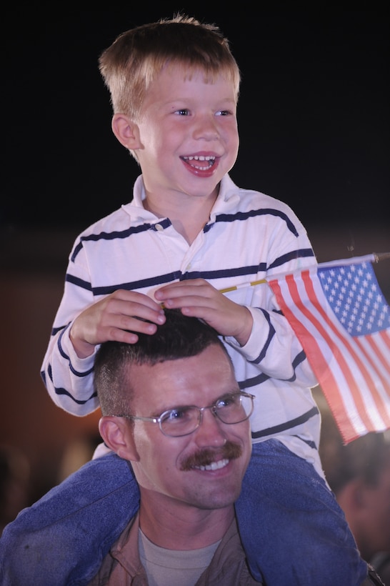 Capt. Louis Heidema, 37th Bomb Squadron weapons systems officer, reunites with son, Jacob, after a six-month deployment to Southwest Asia, July 29. While deployed, the 37th Bomb Squadron provided decisive and sustainable combat airpower for global response.(U.S. Air Force photo/Airman Corey Hook)(Released) 