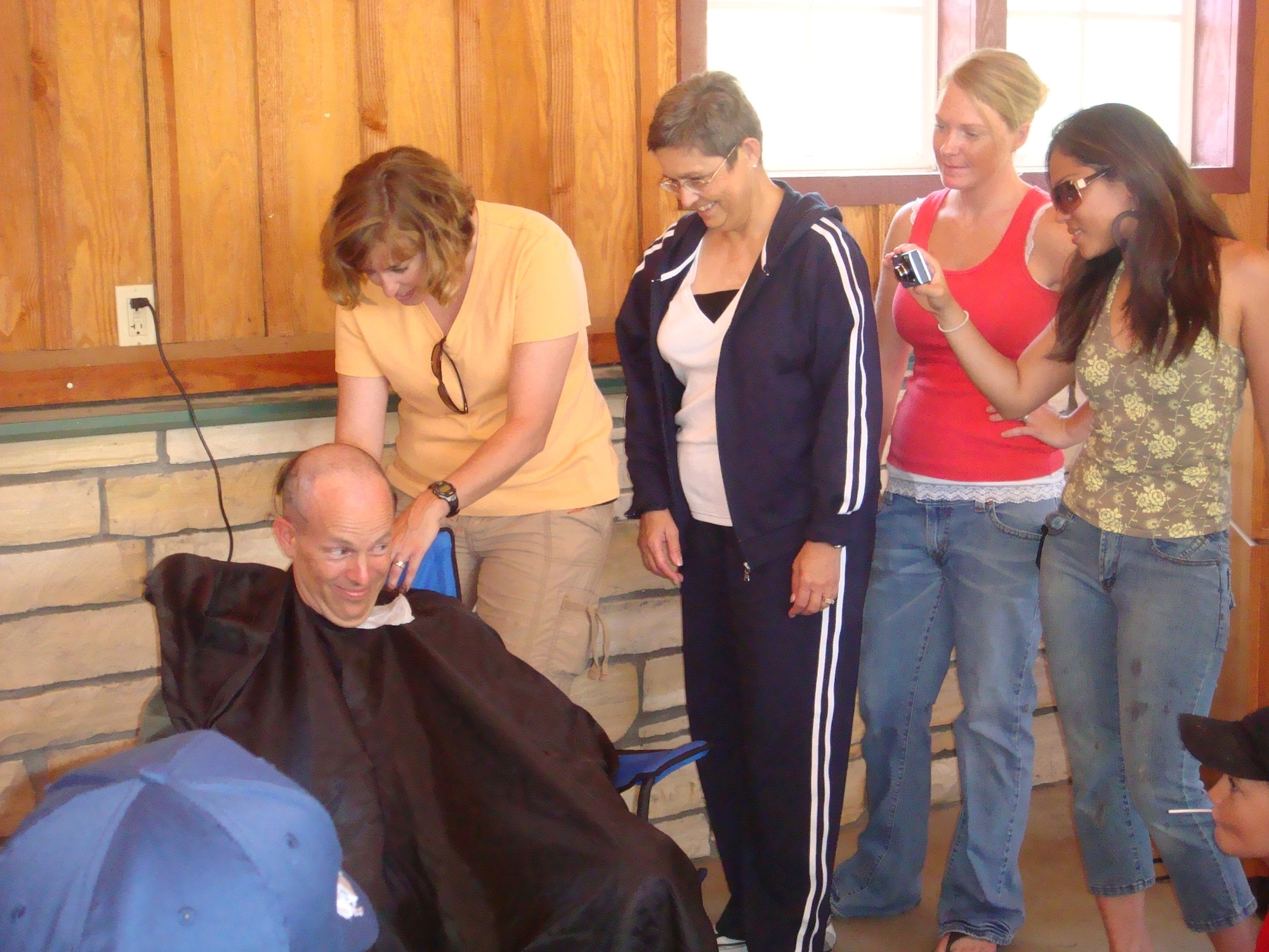 VANDENBERG AIR FORCE BASE, Calif. --  Col. Joseph Anderson, 30th Medical Group commander, gets his head shaved, making good on a promise he would do so if his group earned an "Excellent" on the 2008 Health Services Inspection. This accomplishment repeats the overall rating earned on the same inspection in 2005. The HSI team assesses the ability of Air Force medical units to fulfill their peacetime and wartime missions, including provision of medical care and support of the host wing mission. (Courtesy photo)     