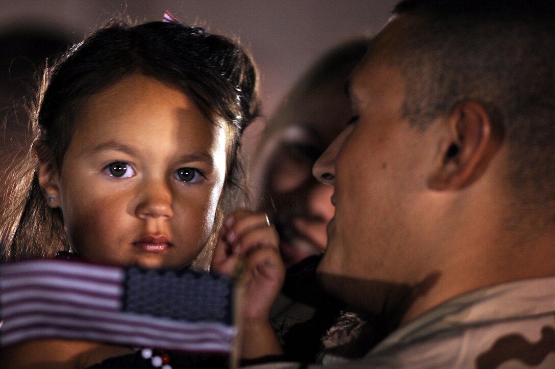 Staff Sgt. Anthony Cathcart, 28th Aircraft maintenance squadron aerospace maintenance jouneyman, is greeted by his daughter, Payton, and wife, Jaclyn, July 29. Sergeant Cathcart was one of approximately 300 Airmen who returned home from a six-month deployment from Southwest Asia. (U.S. Air Force photo/Airman Corey Hook)