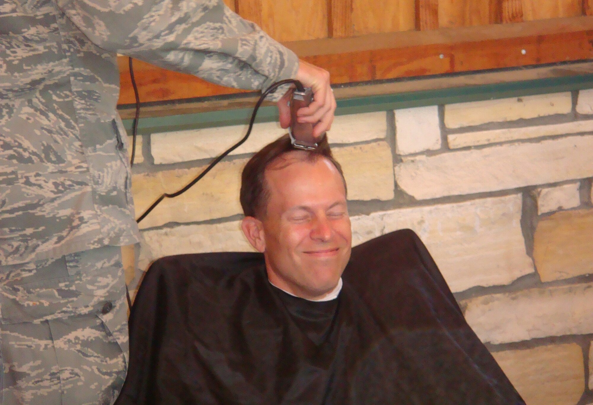 VANDENBERG AIR FORCE BASE, Calif. --  Col. Joseph Anderson, 30th Medical Group commander, gets his head shaved, making good on a promise he would do so if his group earned an "Excellent" on the 2008 Health Services Inspection. This accomplishment repeats the overall rating earned on the same inspection in 2005. The HSI team assesses the ability of Air Force medical units to fulfill their peacetime and wartime missions, including provision of medical care and support of the host wing mission. (Courtesy photo)     