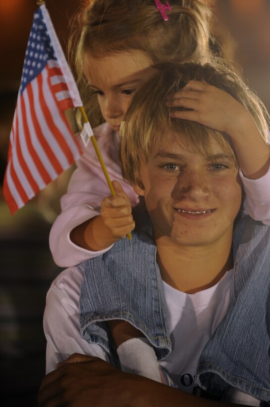 Zane and Alexus Shelton wait to greet their father, Maj. Norman Shelton, 37th  Bomb Squadron assistant director of operations, as he returns from a six-month deployment to Southwest Asia July 29. While deployed, members of the 37 BS provided rapid, decisive and sustainable combat airpower. (US Air Force Photo/Airman 1st Class Adam Grant)



