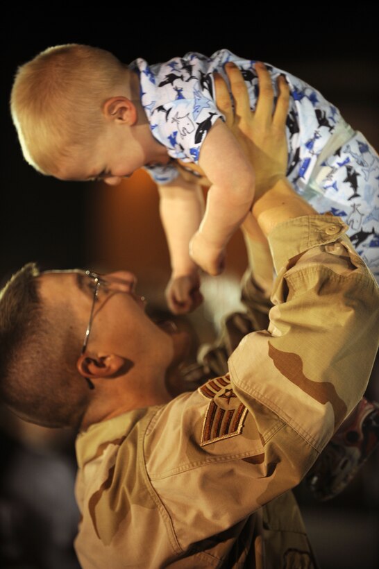 Staff Sgt. Nicholas Todd, 28th Maintenance Operations Squadron weapons system operator plays with his son after returning from a six-month deployment to Southwest Asia July 29. Airmen provided the theater commander the critical long-range strike capability unique to the B-1B Lancer bomber and executed the ability to rapidly deliver massive quantities of precision and non-precision weapons against any adversary, anywhere in the world, at any time. (US Air Force Photo/Airman 1st Class Adam Grant) 



