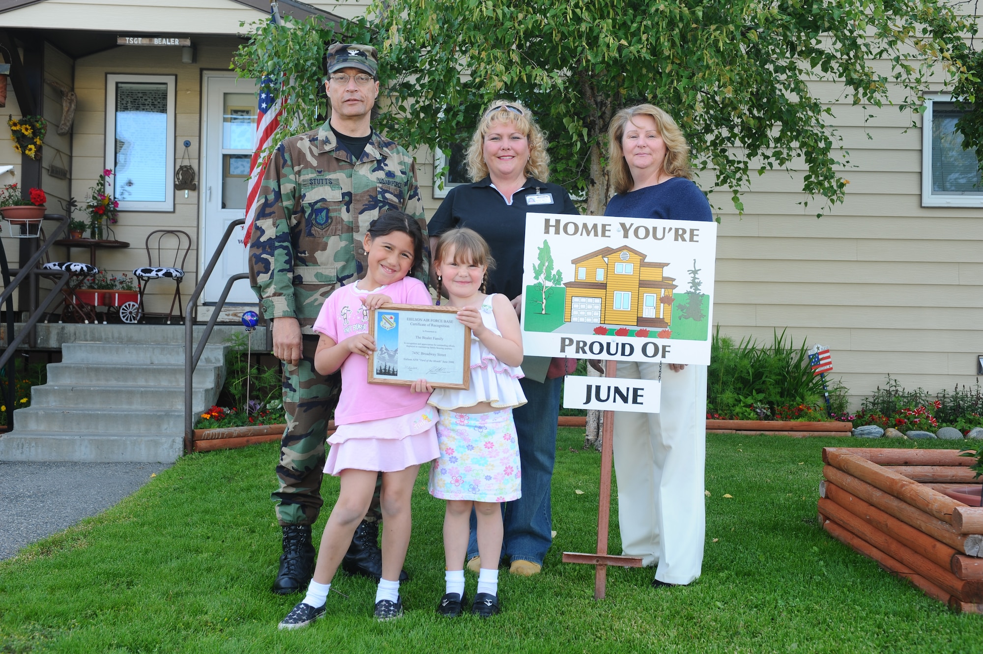 Rachelle Bealer and her two daughters proudly display their Home You're Proud of award with Col. John Stutts, 354th Mission Support Group commander, and Lorie Dallas, 354th CES military family housing, July 25, 2008 at Eielson Air Force Base, Alaska. They won the HYPO award for the month of June; each winning household received gift cards from various units on base and businesses off base. She is the spouse of Tech. Sgt. Richard Bealer, 354th Aircraft Maintenance Squadron. (U.S. Air Force photo by Airman 1st Class Jonathan Snyder)
